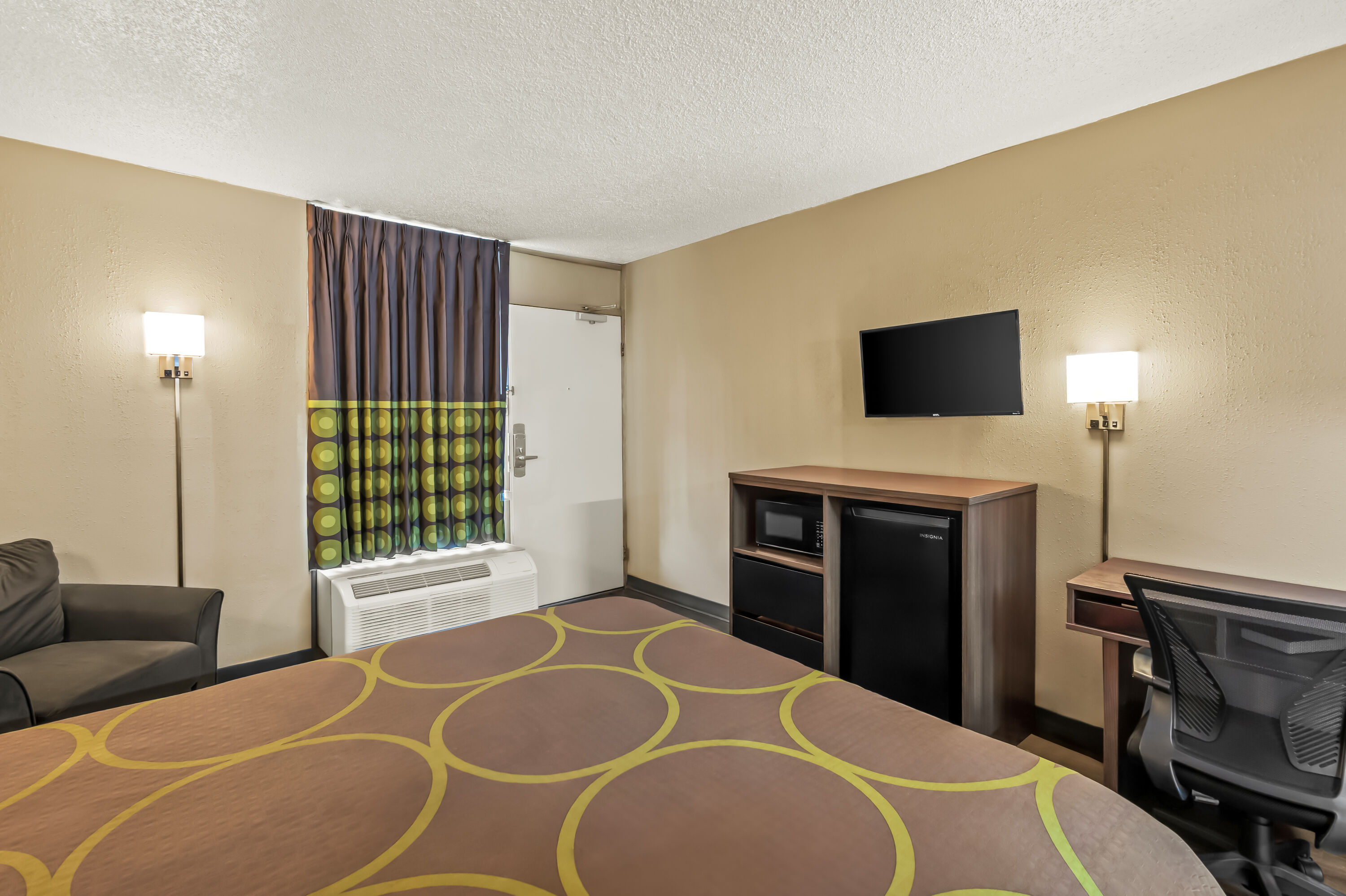 Queen bed guest room at the Super 8 by Wyndham Commerce in Commerce, Georgia