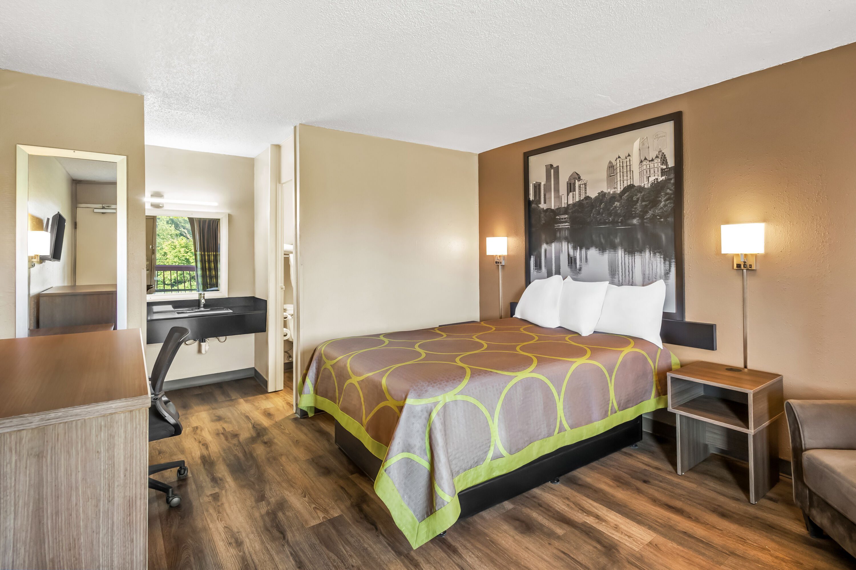 Queen bed guest room at the Super 8 by Wyndham Commerce in Commerce, Georgia