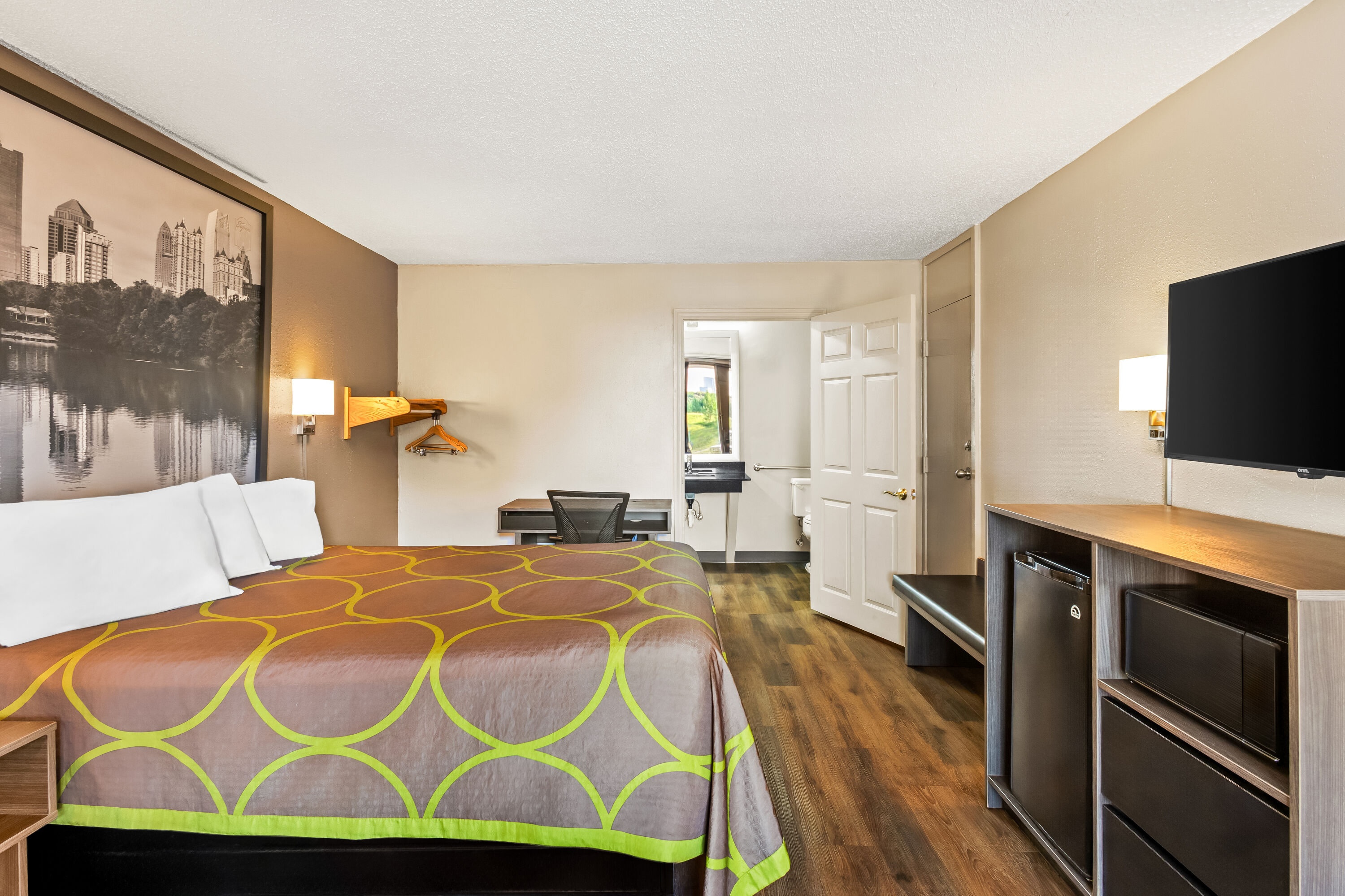 Queen bed guest room at the Super 8 by Wyndham Commerce in Commerce, Georgia