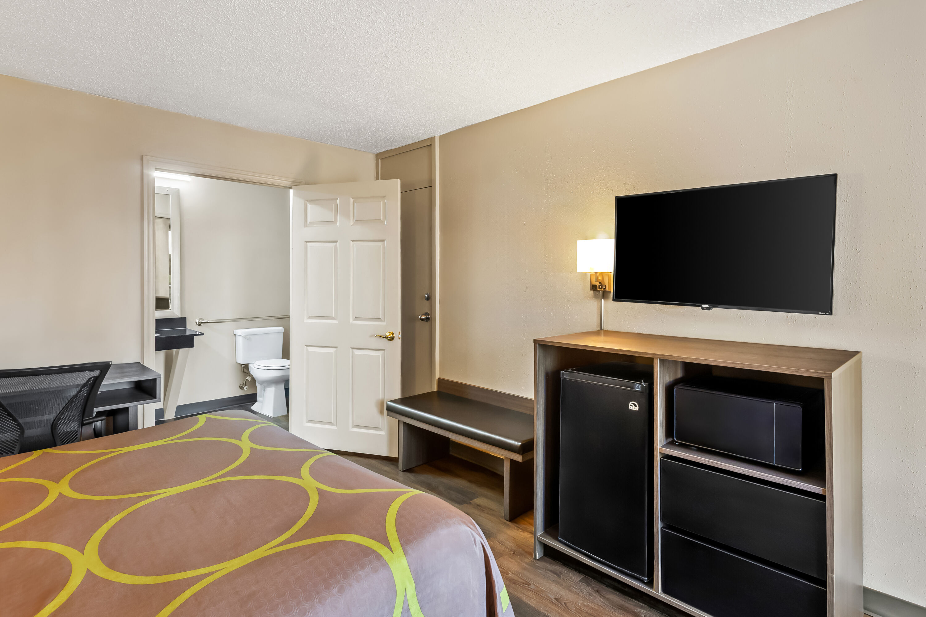 Queen bed guest room at the Super 8 by Wyndham Commerce in Commerce, Georgia