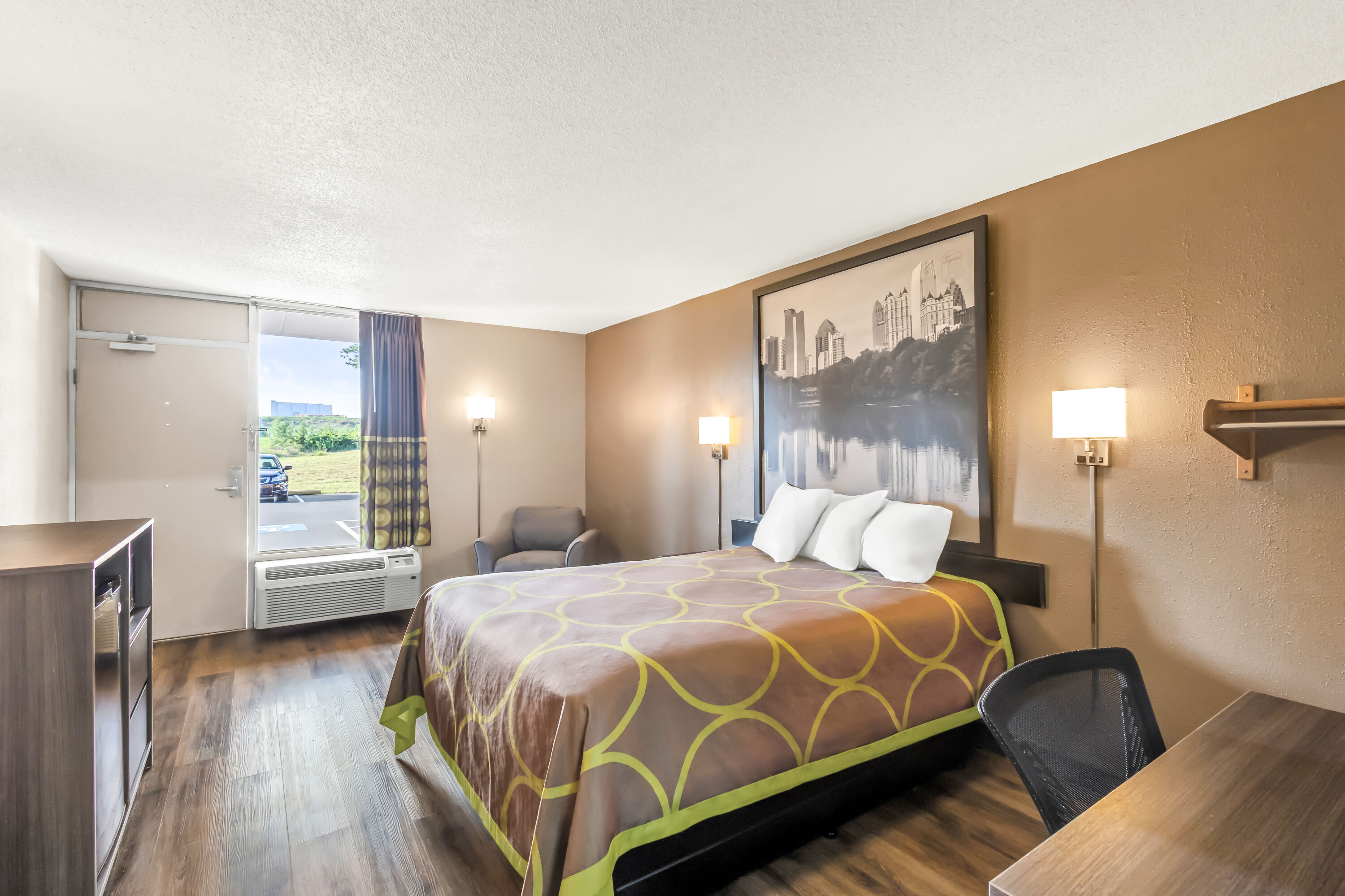 Queen bed guest room at the Super 8 by Wyndham Commerce in Commerce, Georgia