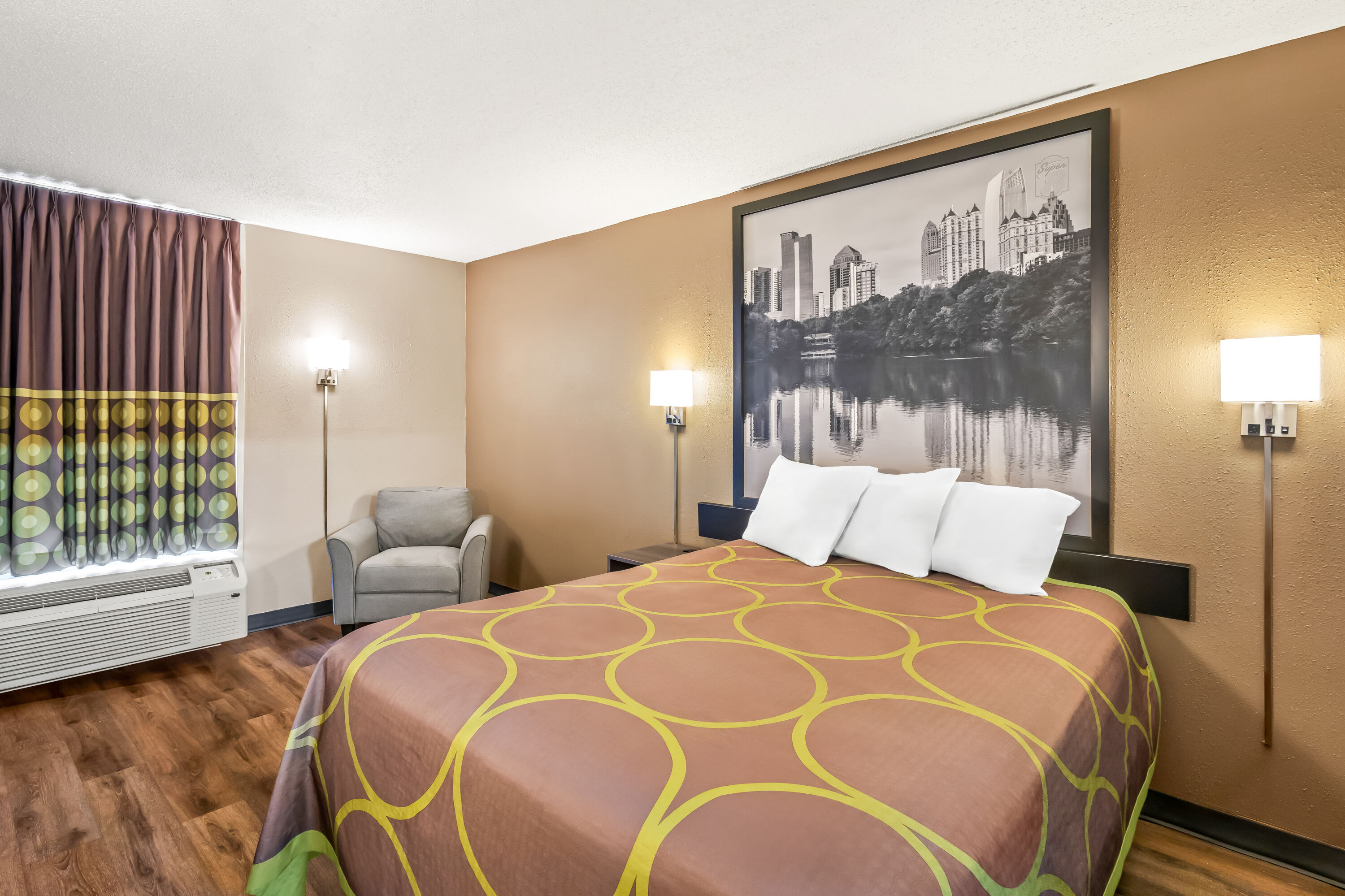 Queen bed guest room at the Super 8 by Wyndham Commerce in Commerce, Georgia