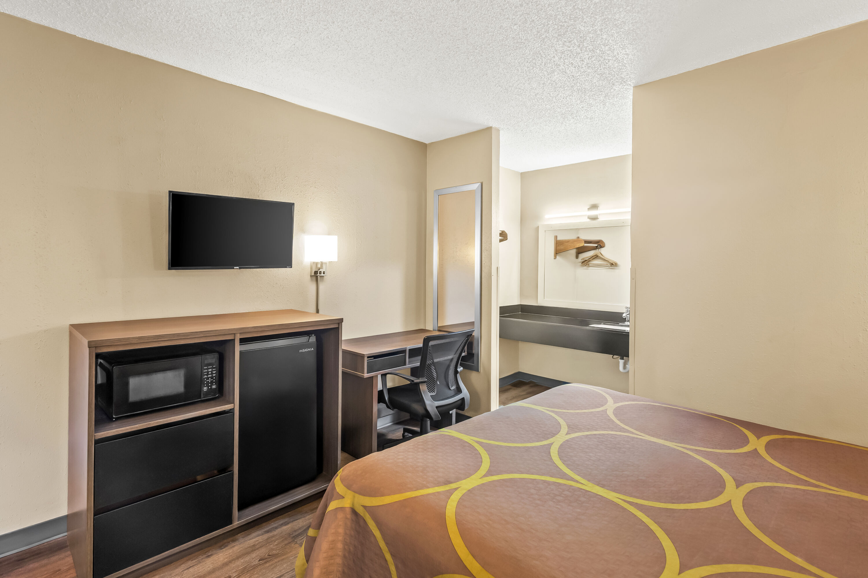 Queen bed guest room at the Super 8 by Wyndham Commerce in Commerce, Georgia