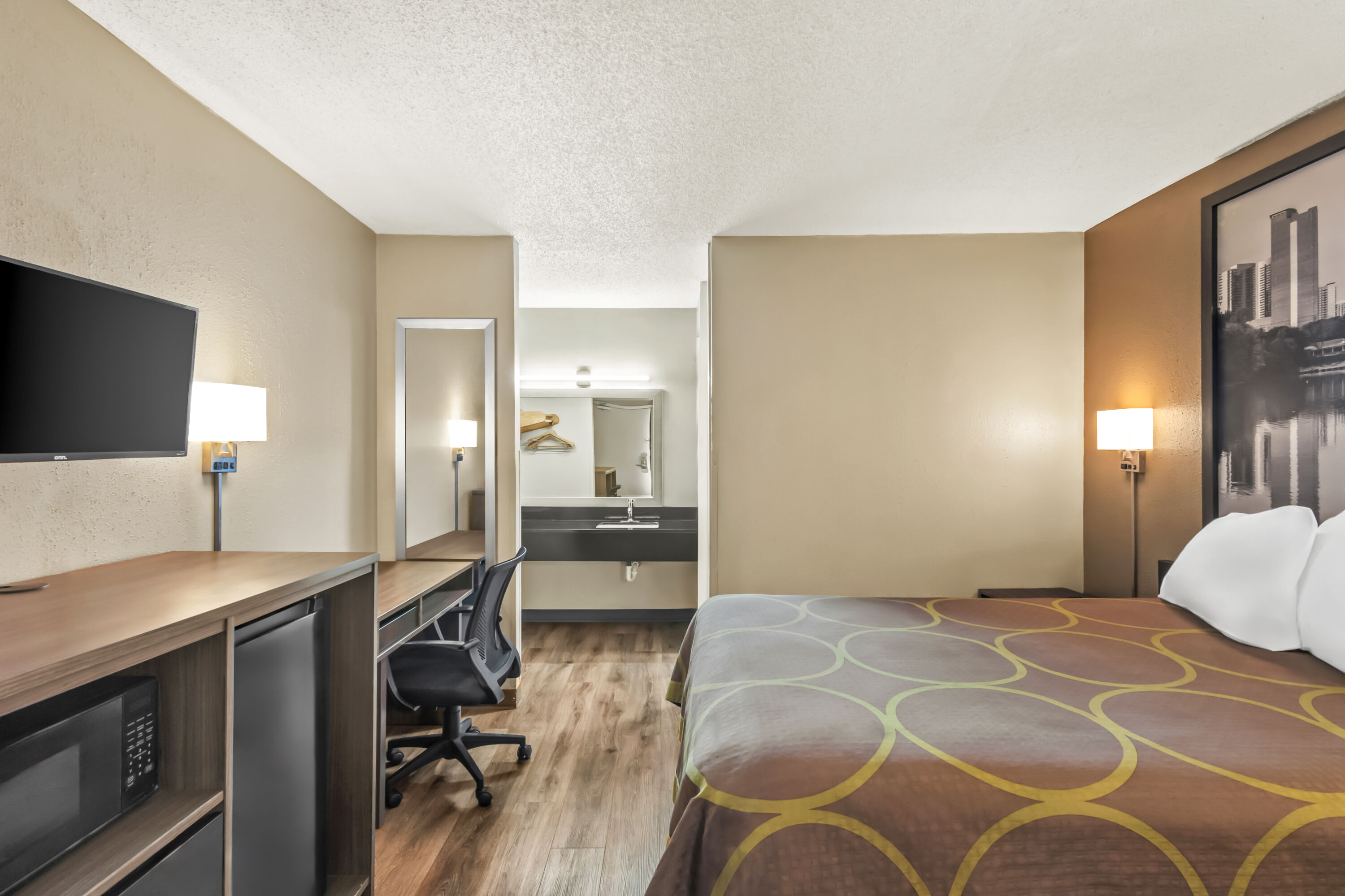 Queen bed guest room at the Super 8 by Wyndham Commerce in Commerce, Georgia