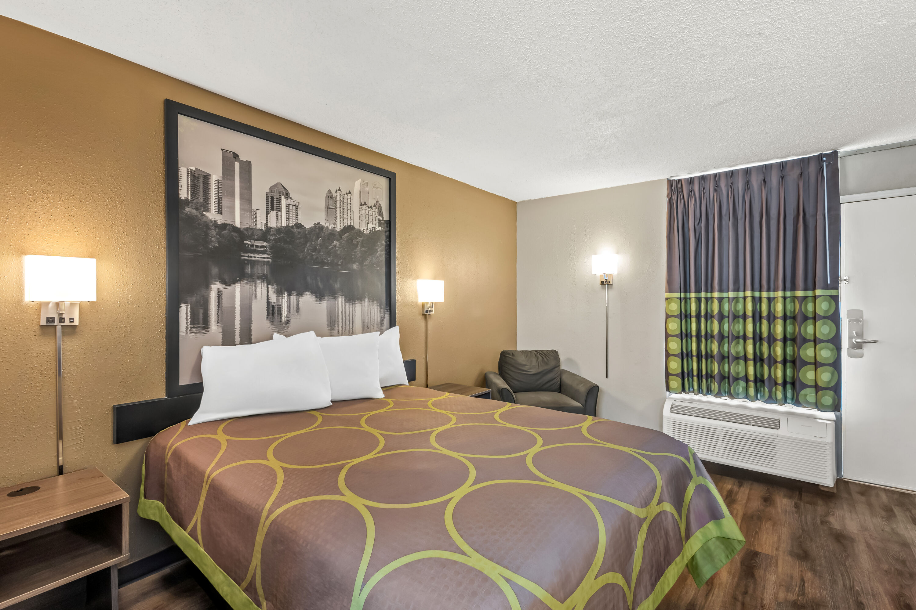 Queen bed guest room at the Super 8 by Wyndham Commerce in Commerce, Georgia