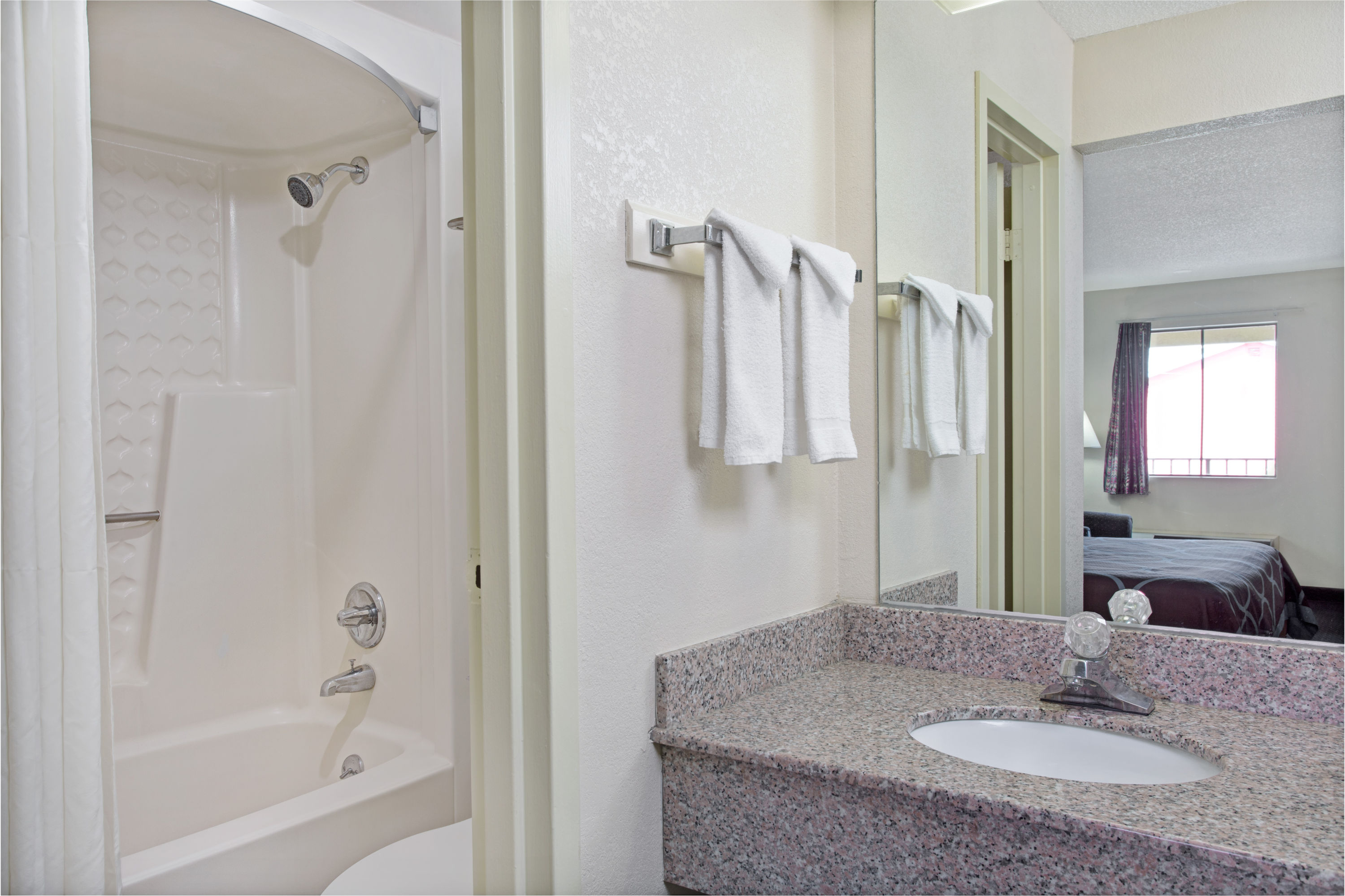 Guest room bath at the Super 8 by Wyndham Suwanee in Suwanee, Georgia