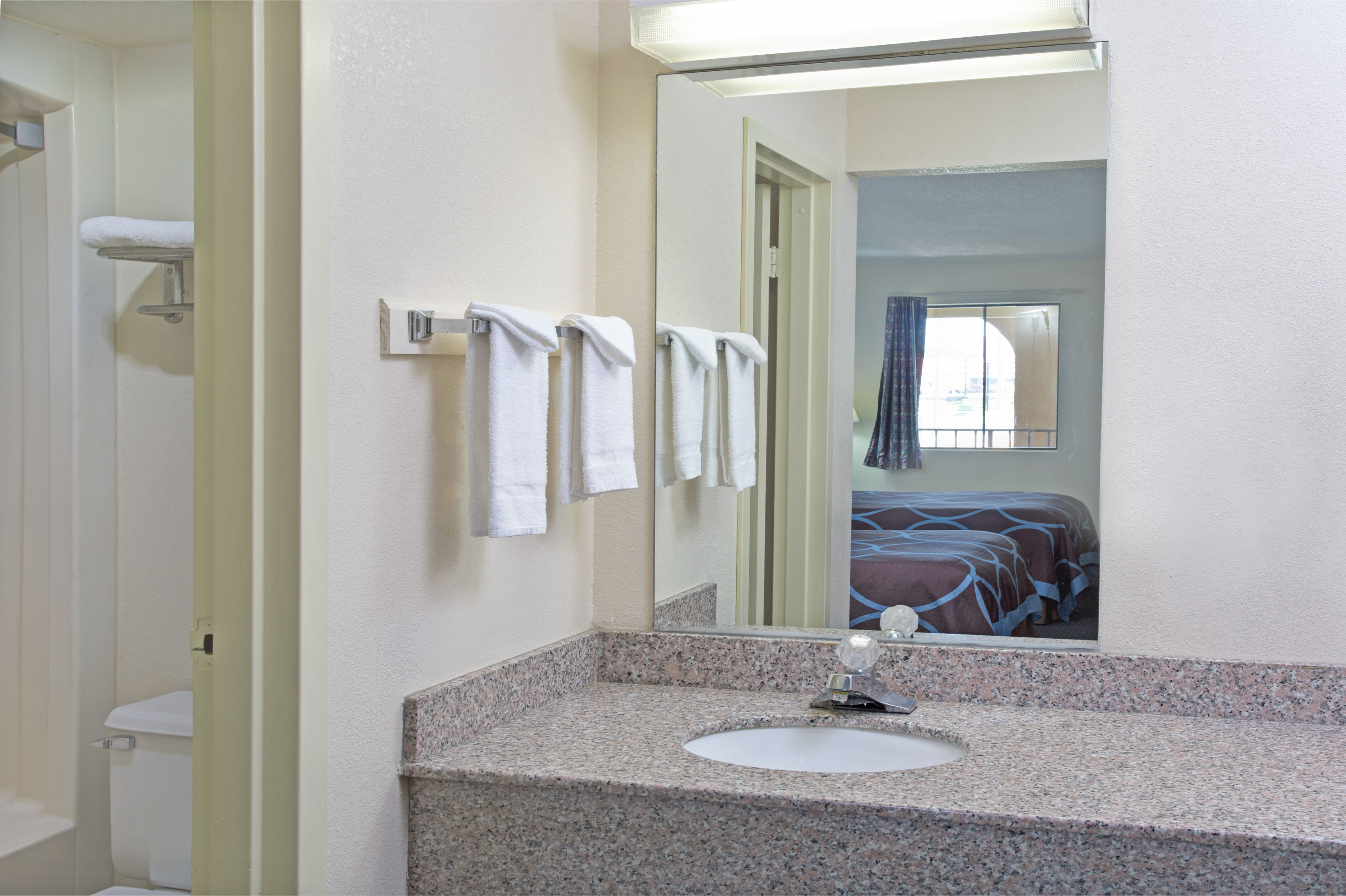 Guest room bath at the Super 8 by Wyndham Suwanee in Suwanee, Georgia