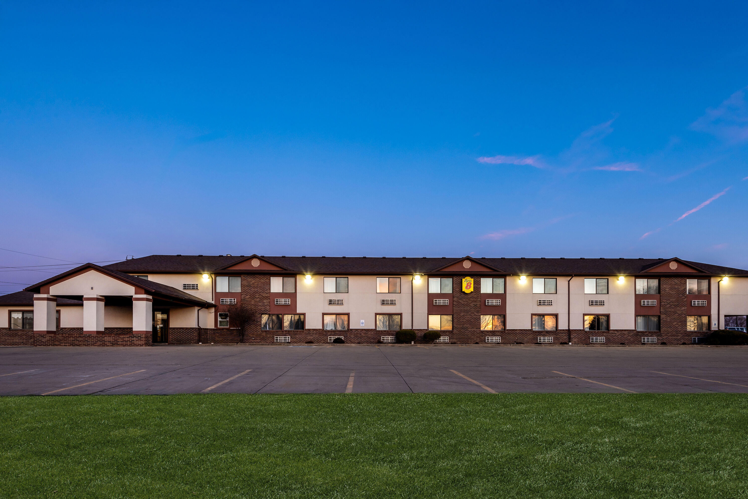 Exterior Night Image of Super 8 by Wyndham Oelwein hotel in Oelwein, Iowa