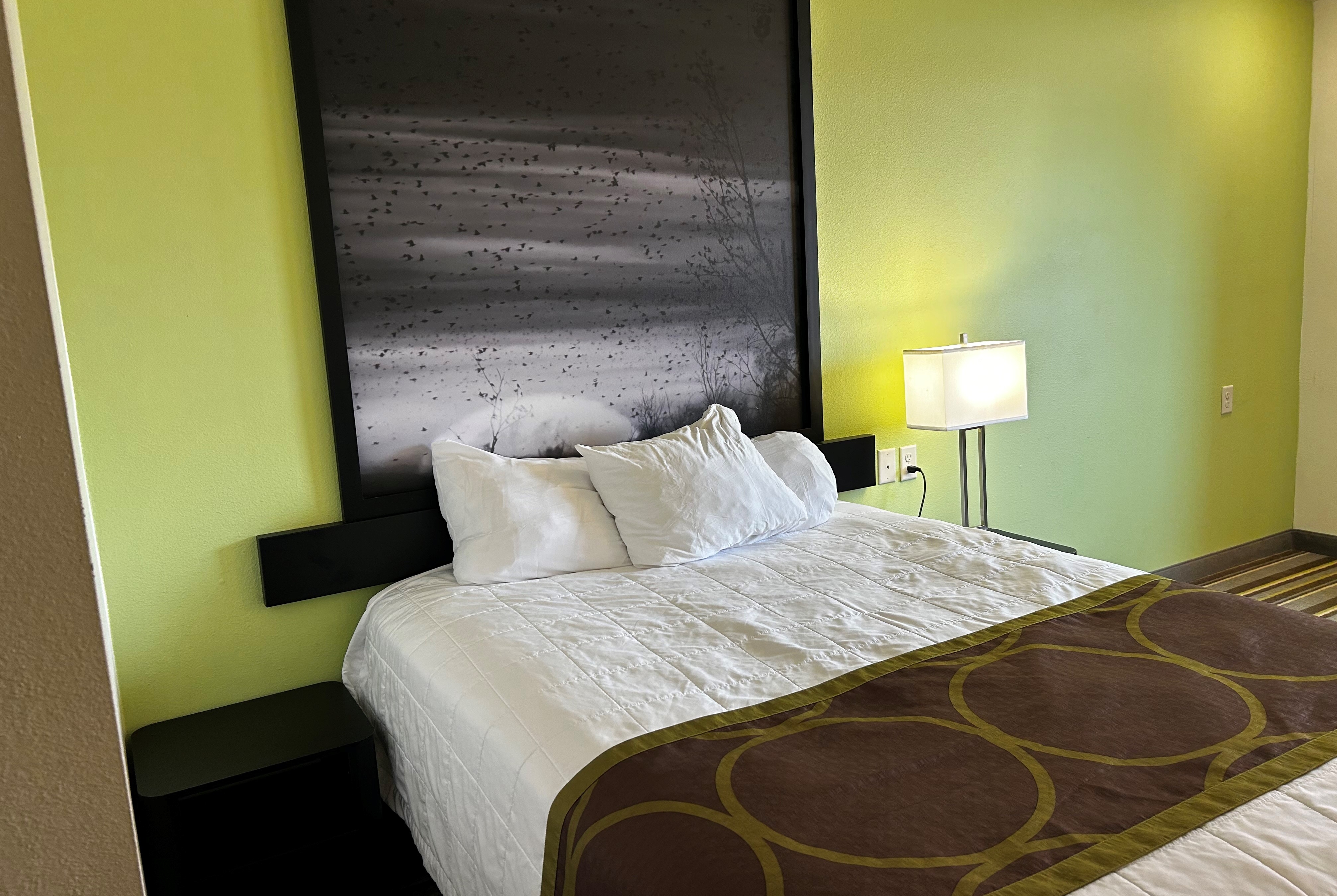 Queen bed guest room at the Super 8 by Wyndham Nebraska City in Percival, Iowa