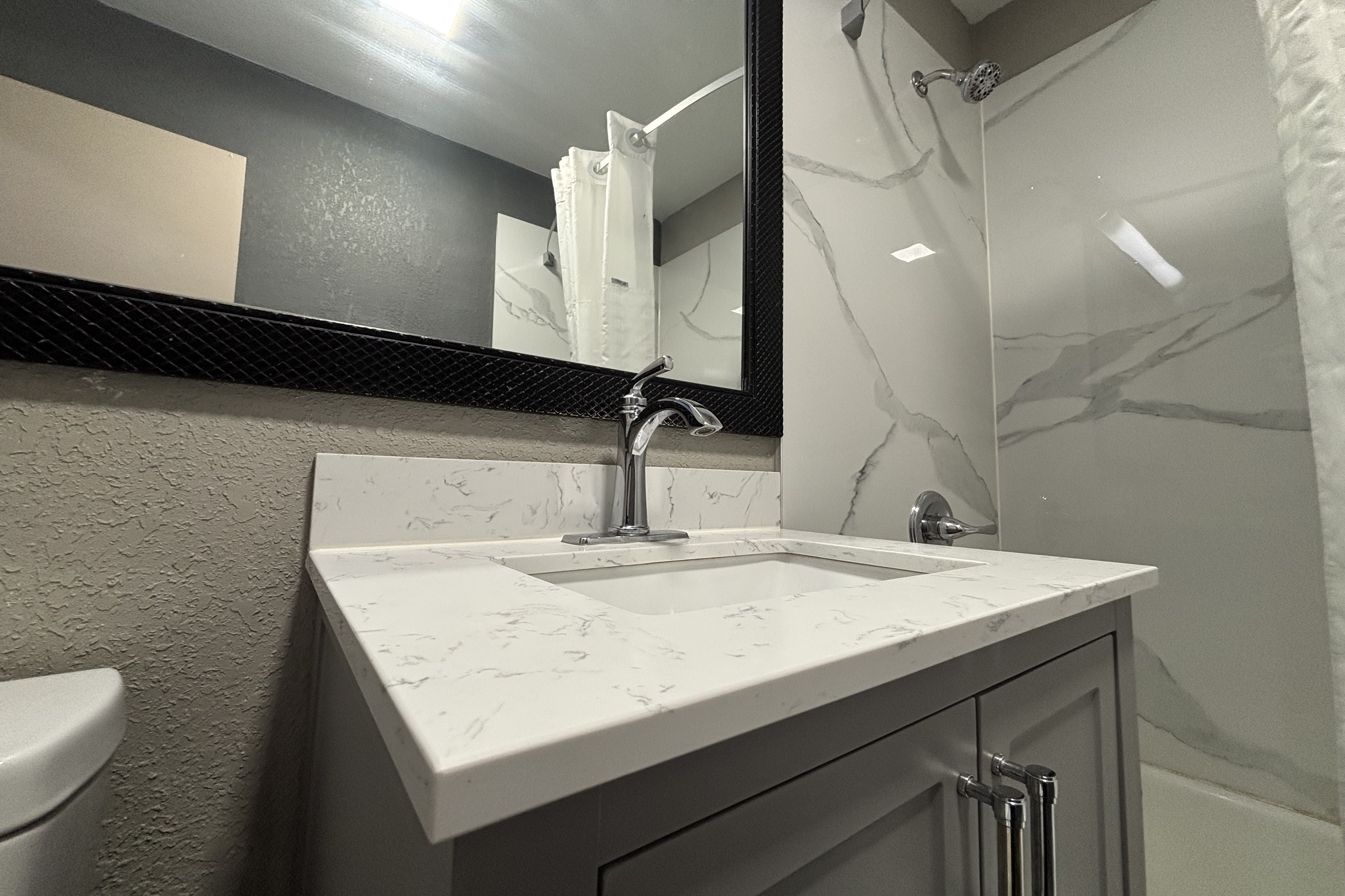 Guest room bath at the Super 8 by Wyndham Belleville IL/St. Louis Area in Belleville, Illinois