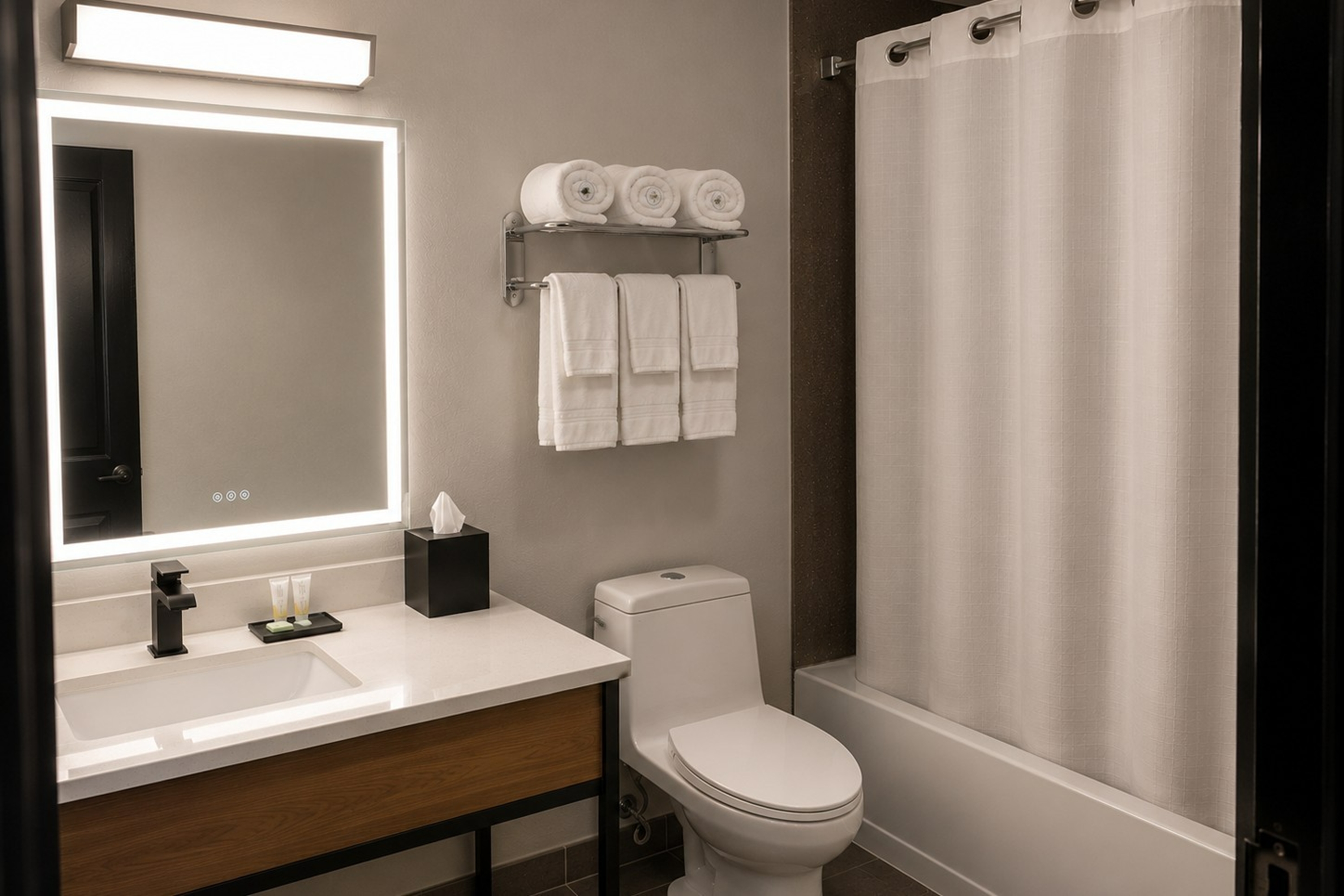 Guest room bath at the Super 8 by Wyndham Champaign in Champaign, Illinois
