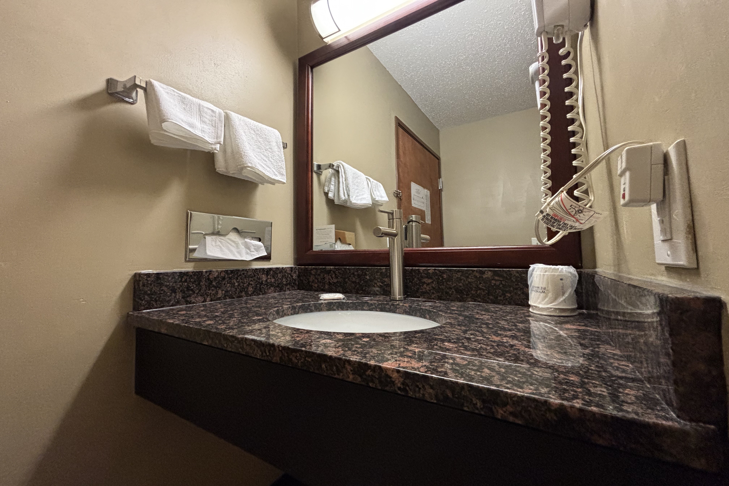 Guest room bath at the Super 8 by Wyndham Normal Bloomington in Normal, Illinois