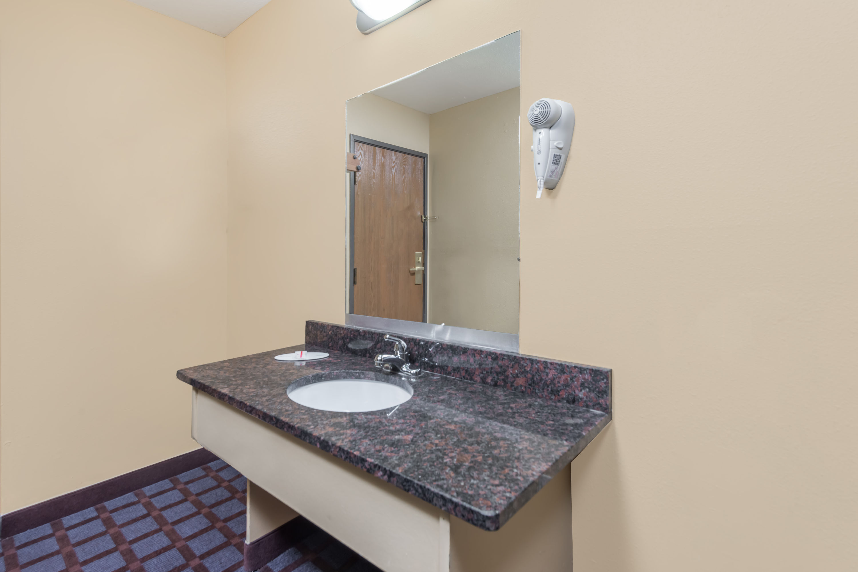 Guest room bath at the Super 8 by Wyndham Okawville in Okawville, Illinois
