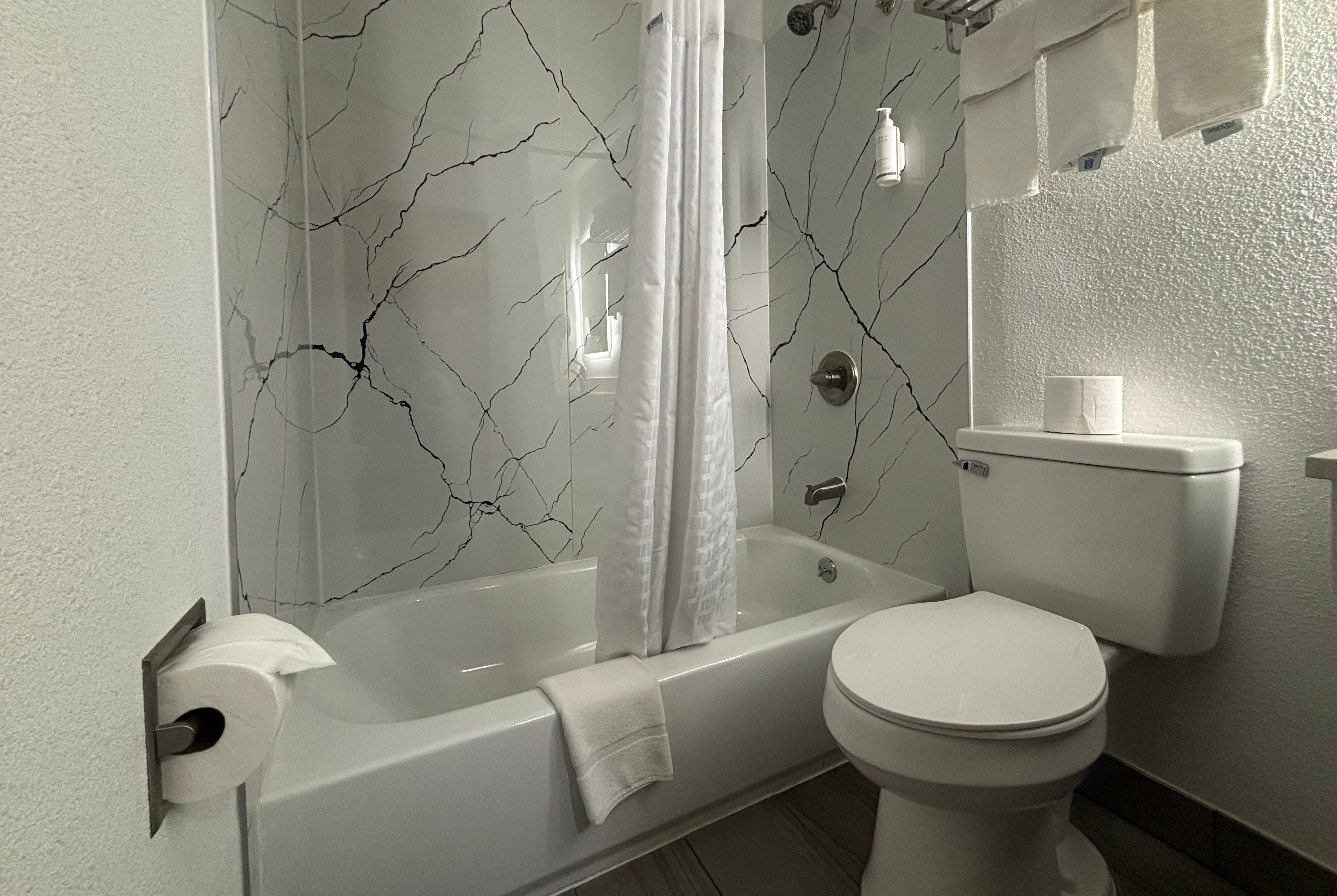 Guest room bath at the Super 8 by Wyndham Peoria in Peoria, Illinois