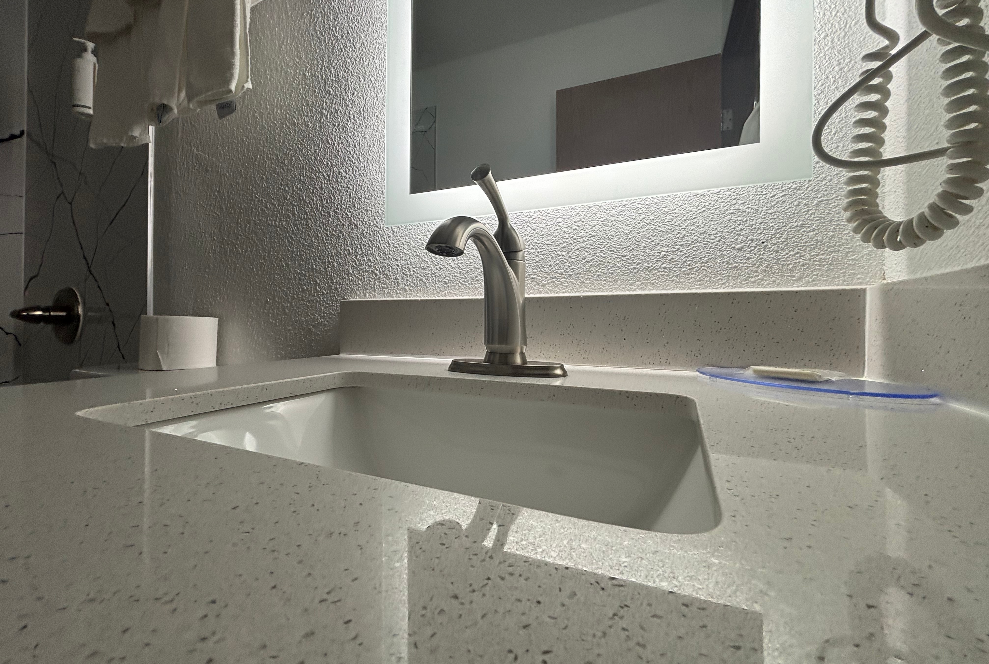 Guest room bath at the Super 8 by Wyndham Peoria in Peoria, Illinois