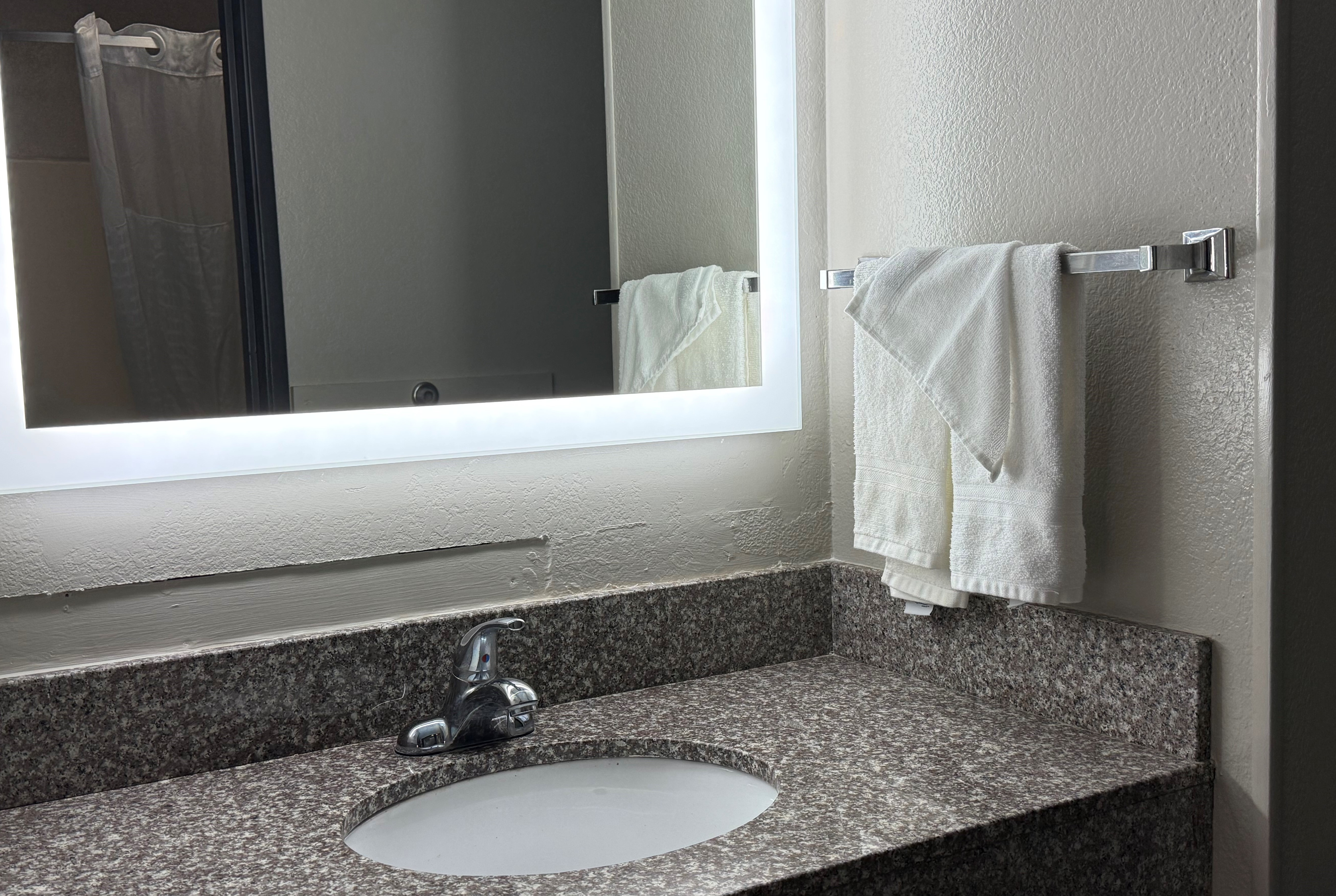 Guest room bath at the Super 8 by Wyndham Evansville East in Evansville, Indiana