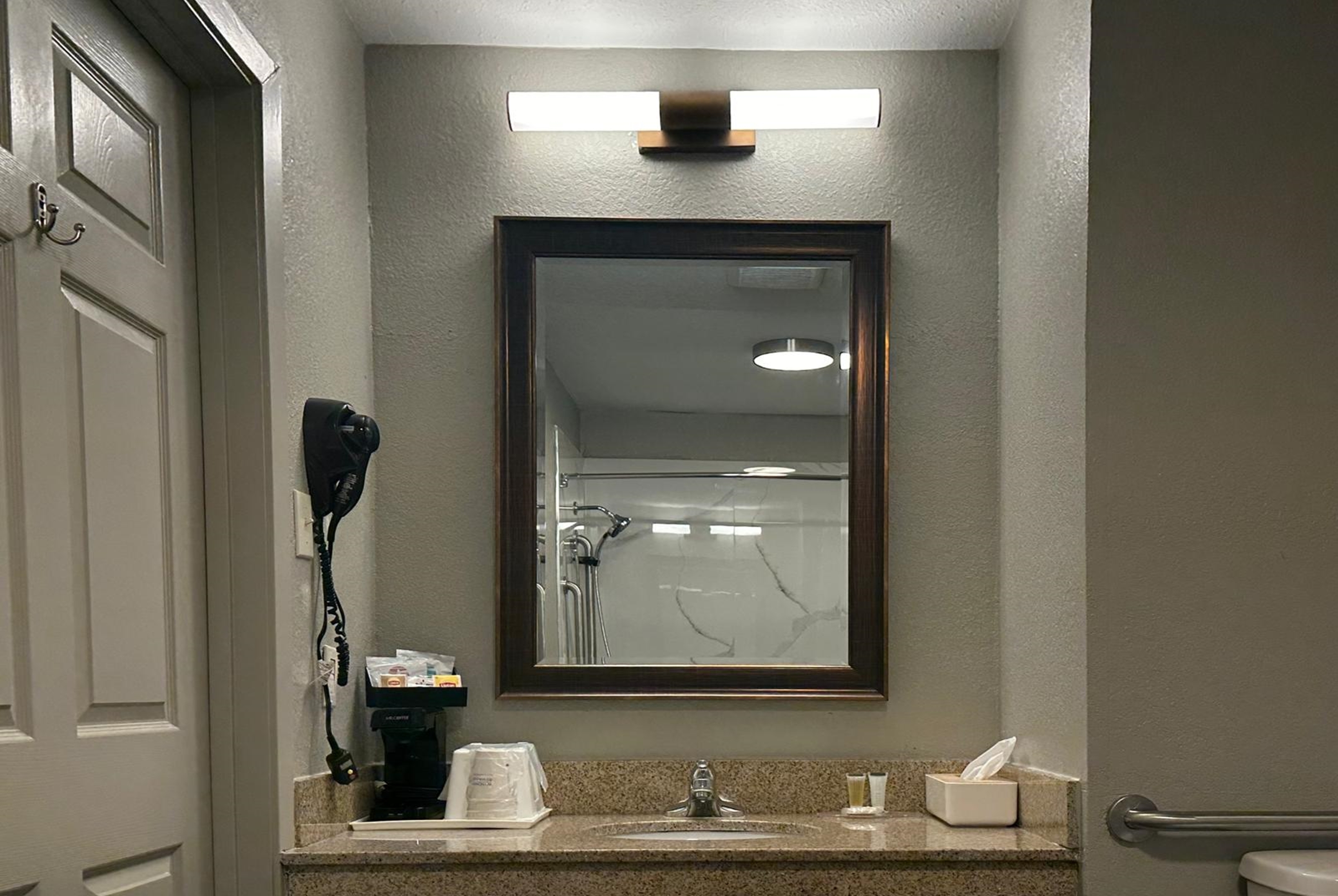 Guest room bath at the Super 8 by Wyndham Monroe in Monroe, Louisiana