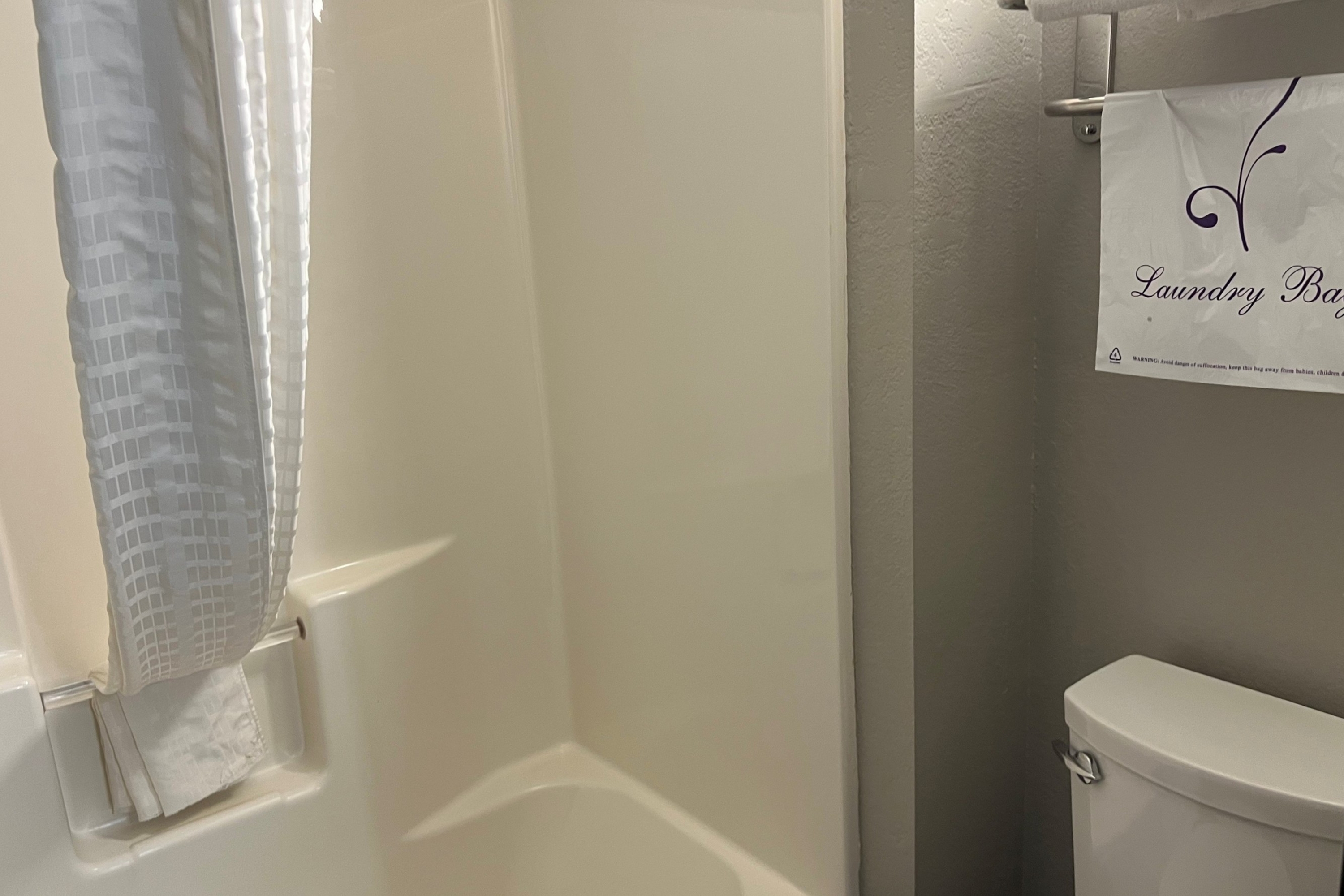 Guest room bath at the Super 8 by Wyndham Lake of the Ozarks in Eldon, Missouri