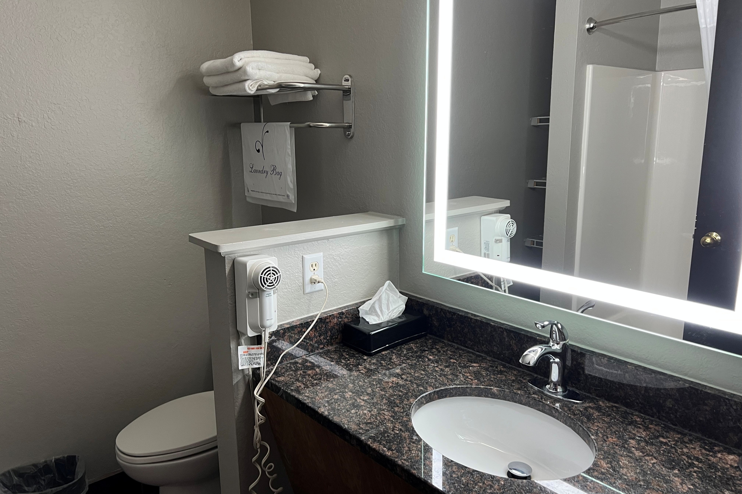 Guest room bath at the Super 8 by Wyndham Lake of the Ozarks in Eldon, Missouri