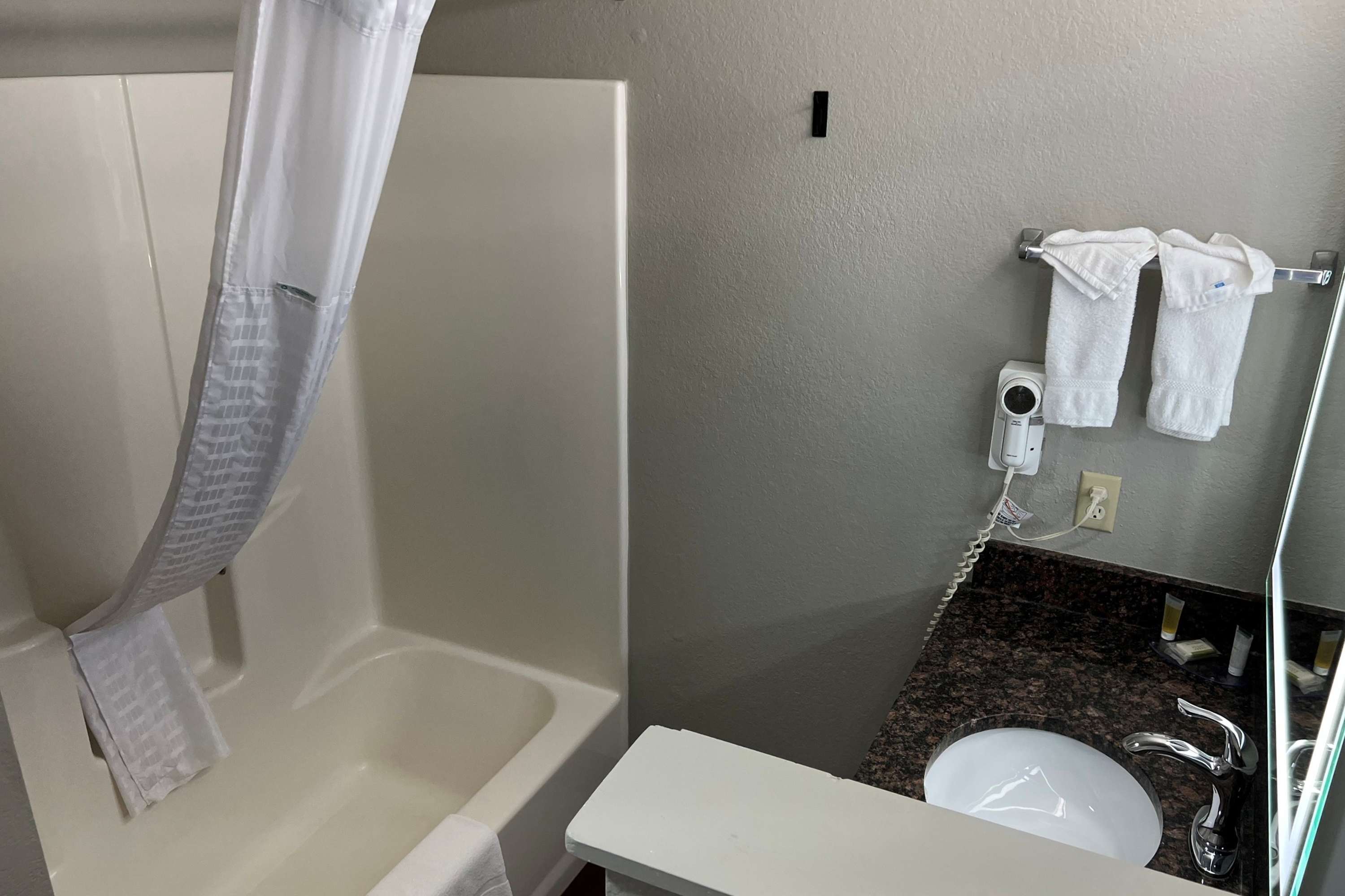 Guest room bath at the Super 8 by Wyndham Lake of the Ozarks in Eldon, Missouri