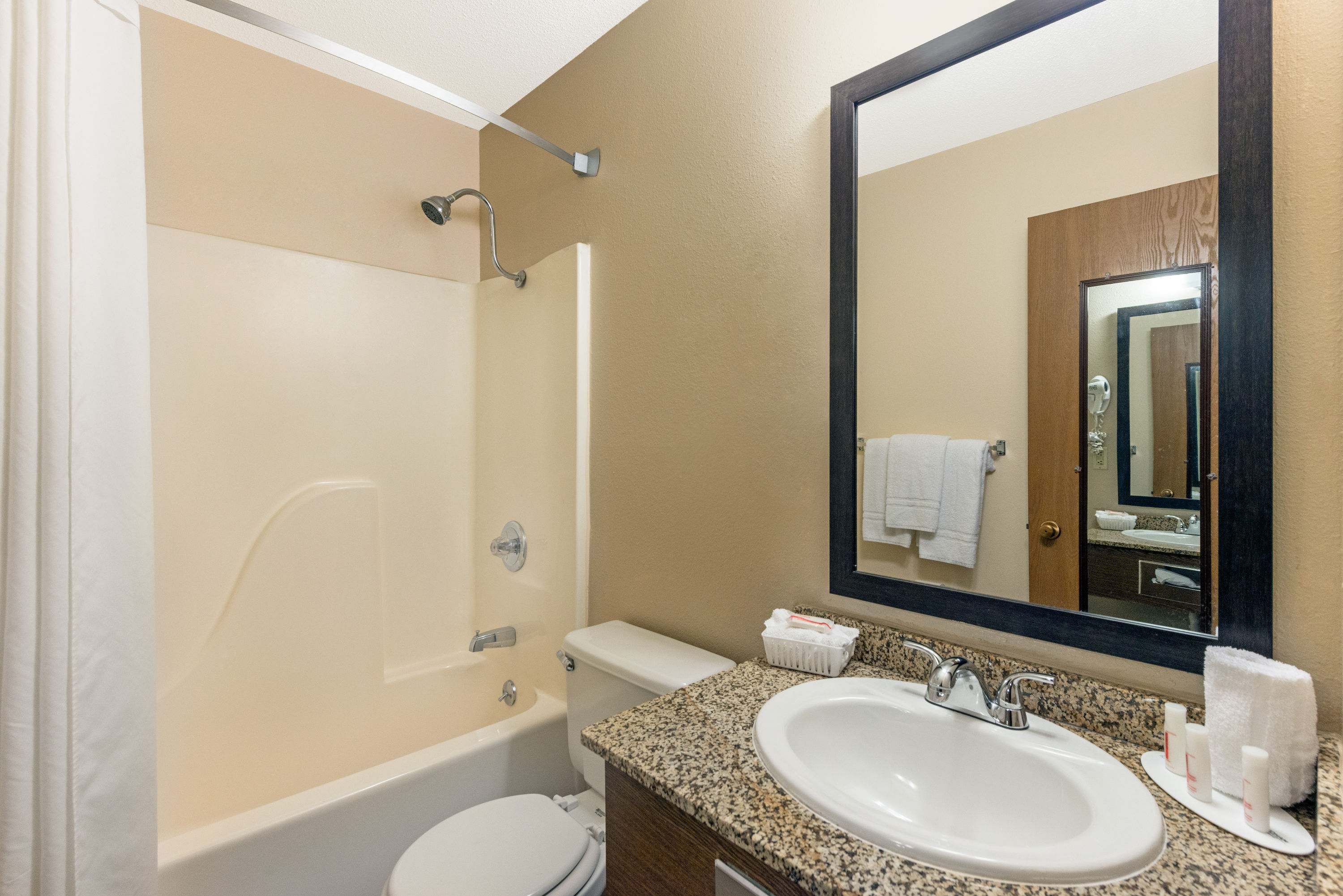 Guest room bath at the Super 8 by Wyndham Poplar Bluff Missouri in Poplar Bluff, Missouri