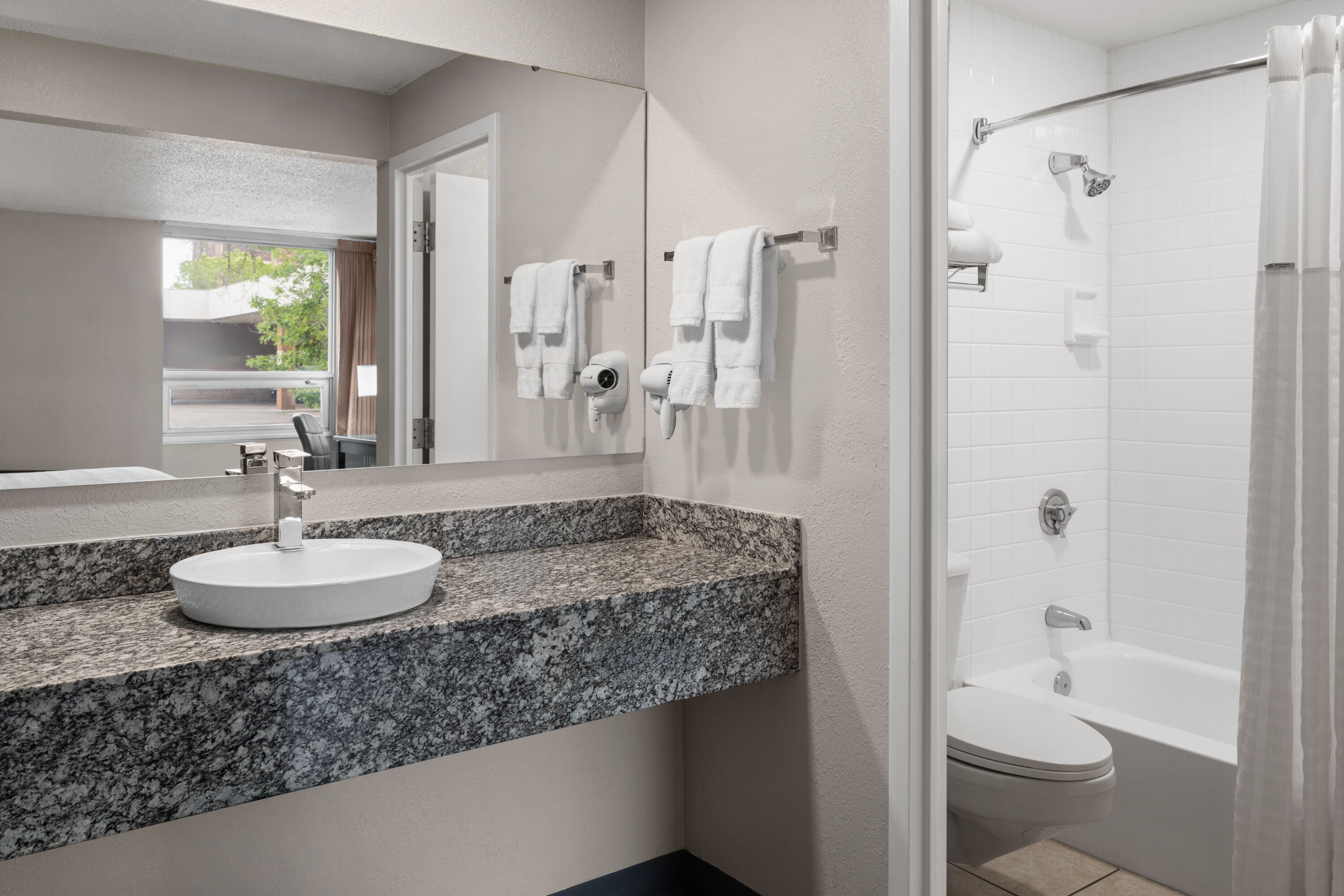 Guest room bath at the Super 8 by Wyndham Great Falls City Center in Great Falls, Montana