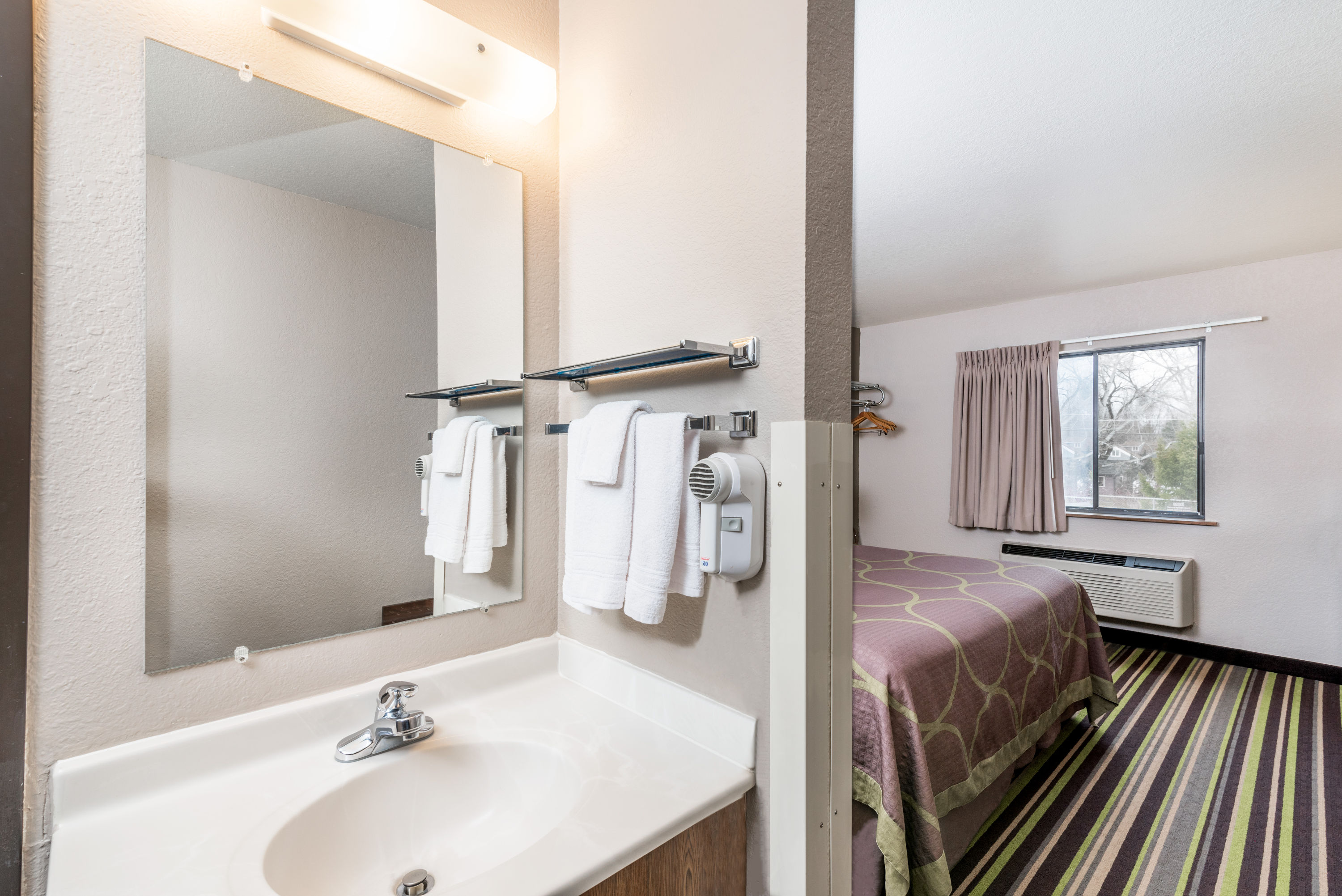 Guest room bath at the Super 8 by Wyndham Kalispell Glacier National Park in Kalispell, Montana