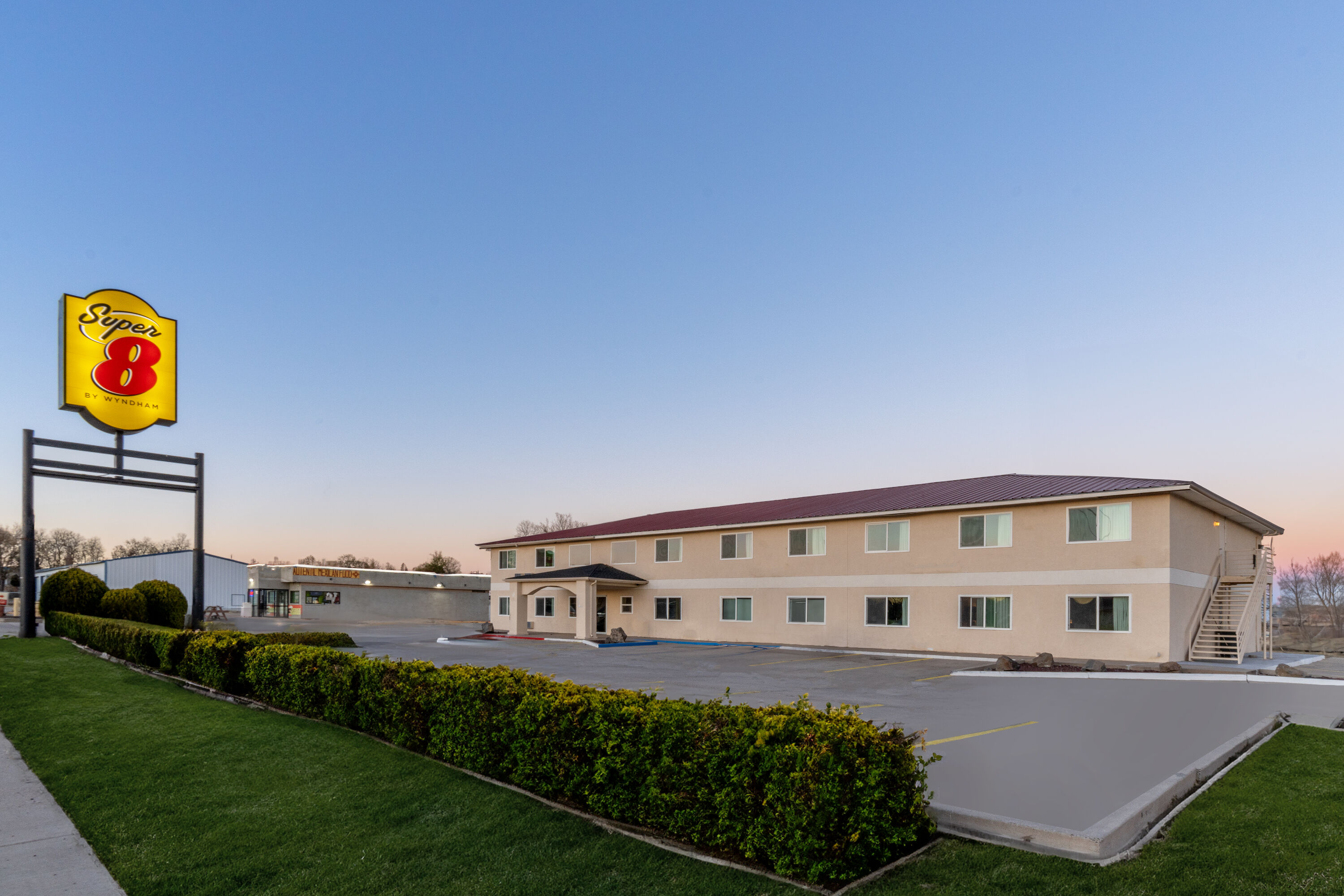 Exterior Dusk Image of Super 8 by Wyndham Clayton hotel in Clayton, New Mexico