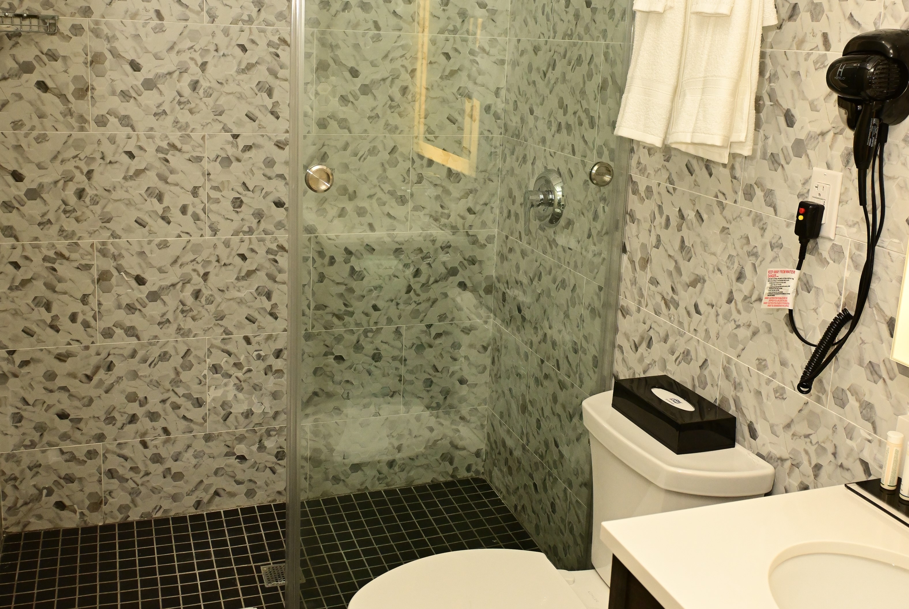 Guest room bath at the Super 8 by Wyndham Bronx Near Botanical Garden in Bronx, New York