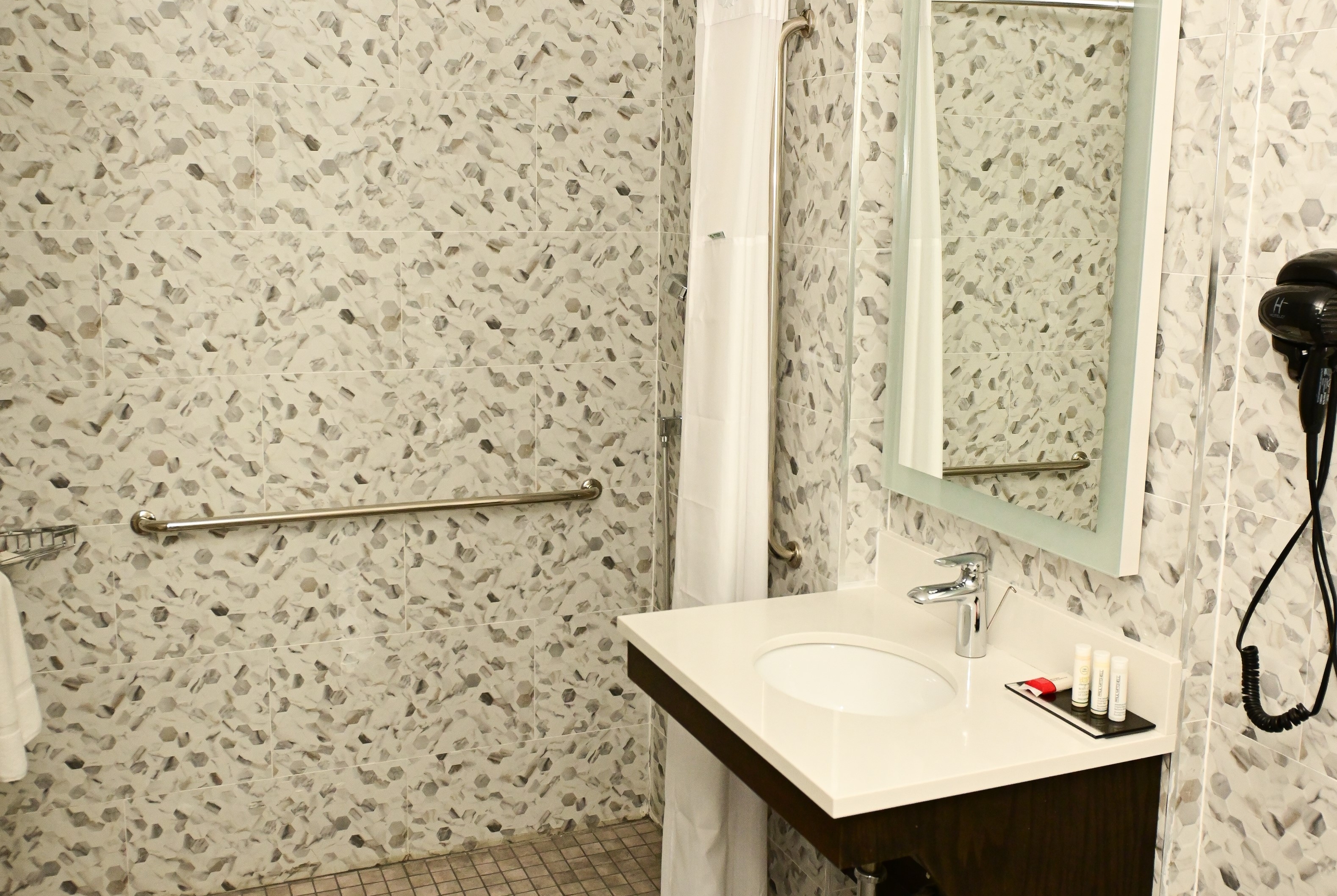 Guest room bath at the Super 8 by Wyndham Bronx Near Botanical Garden in Bronx, New York