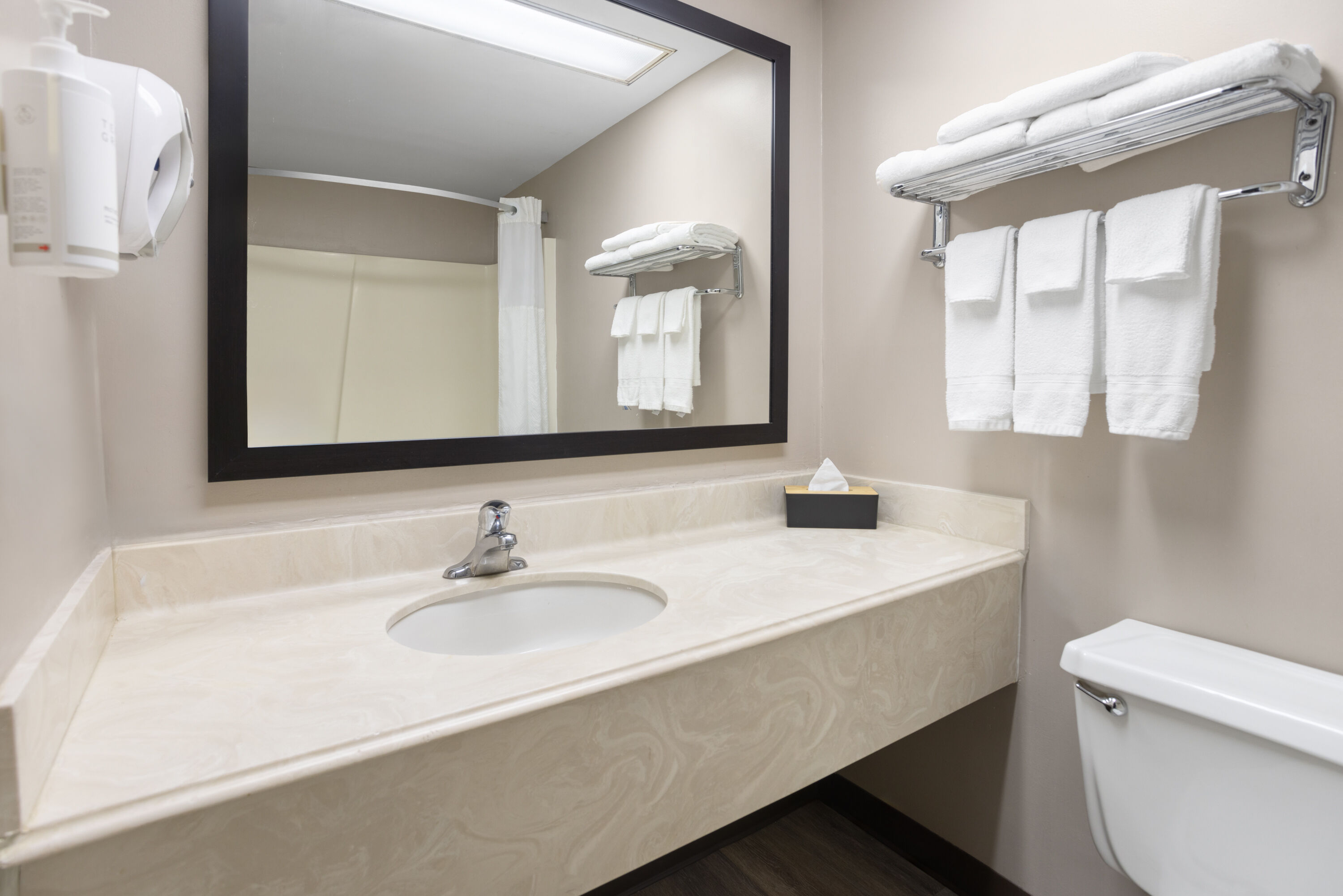 Guest room bath at the Super 8 by Wyndham Henrietta/Rochester Area in Henrietta, New York