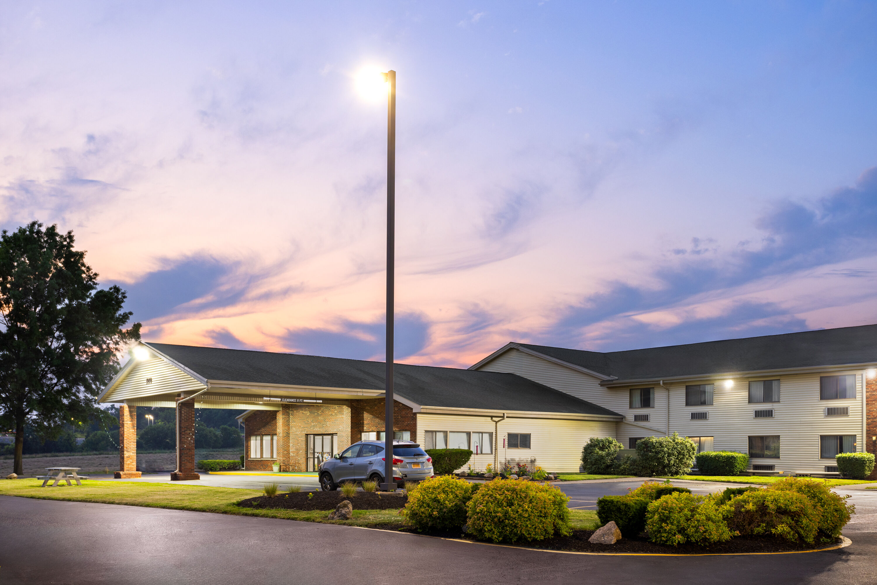 Exterior Dusk Image of Super 8 by Wyndham Henrietta/Rochester Area hotel in Henrietta, New York