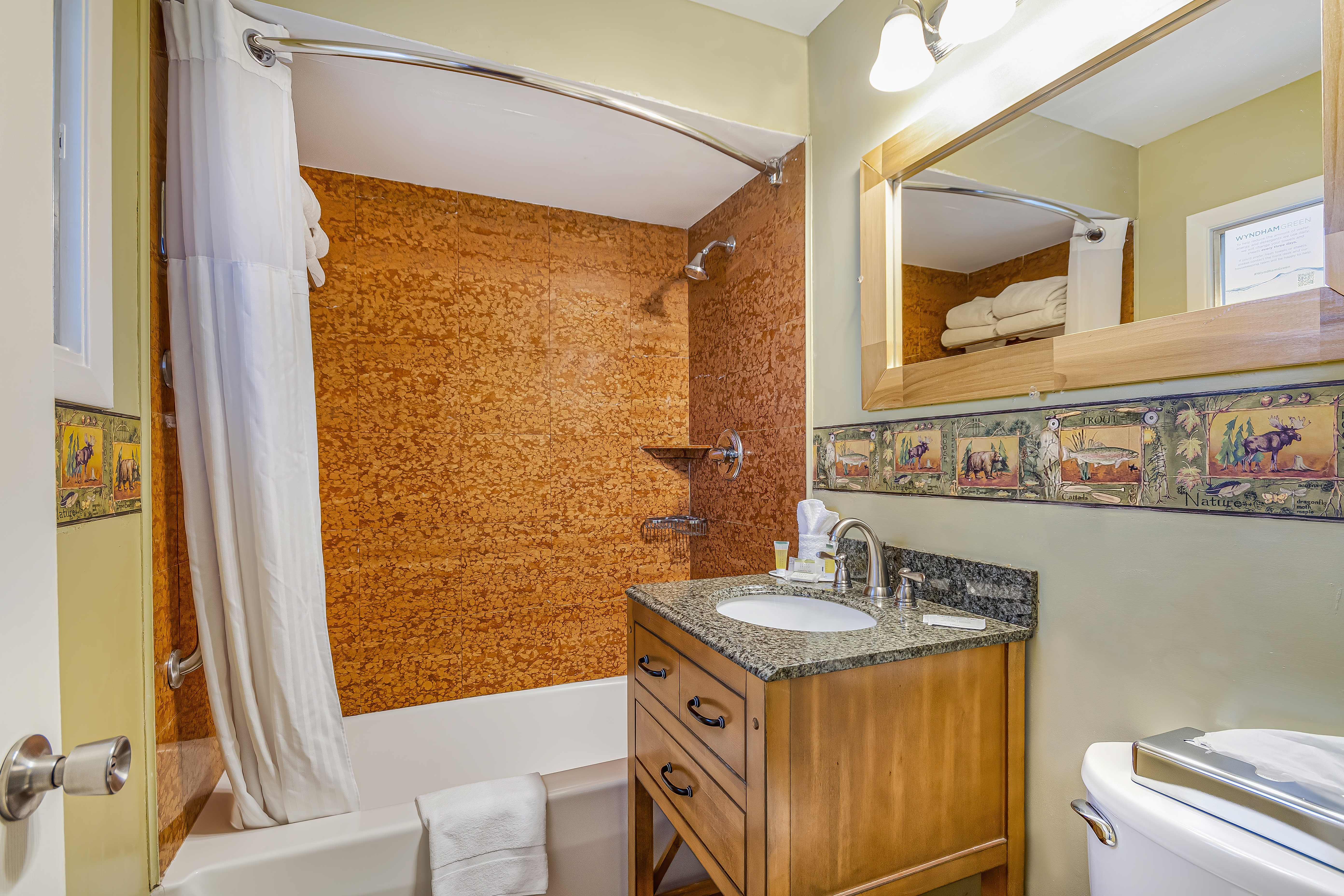 Guest room bath at the Super 8 by Wyndham Lake George/Downtown in Lake George, New York