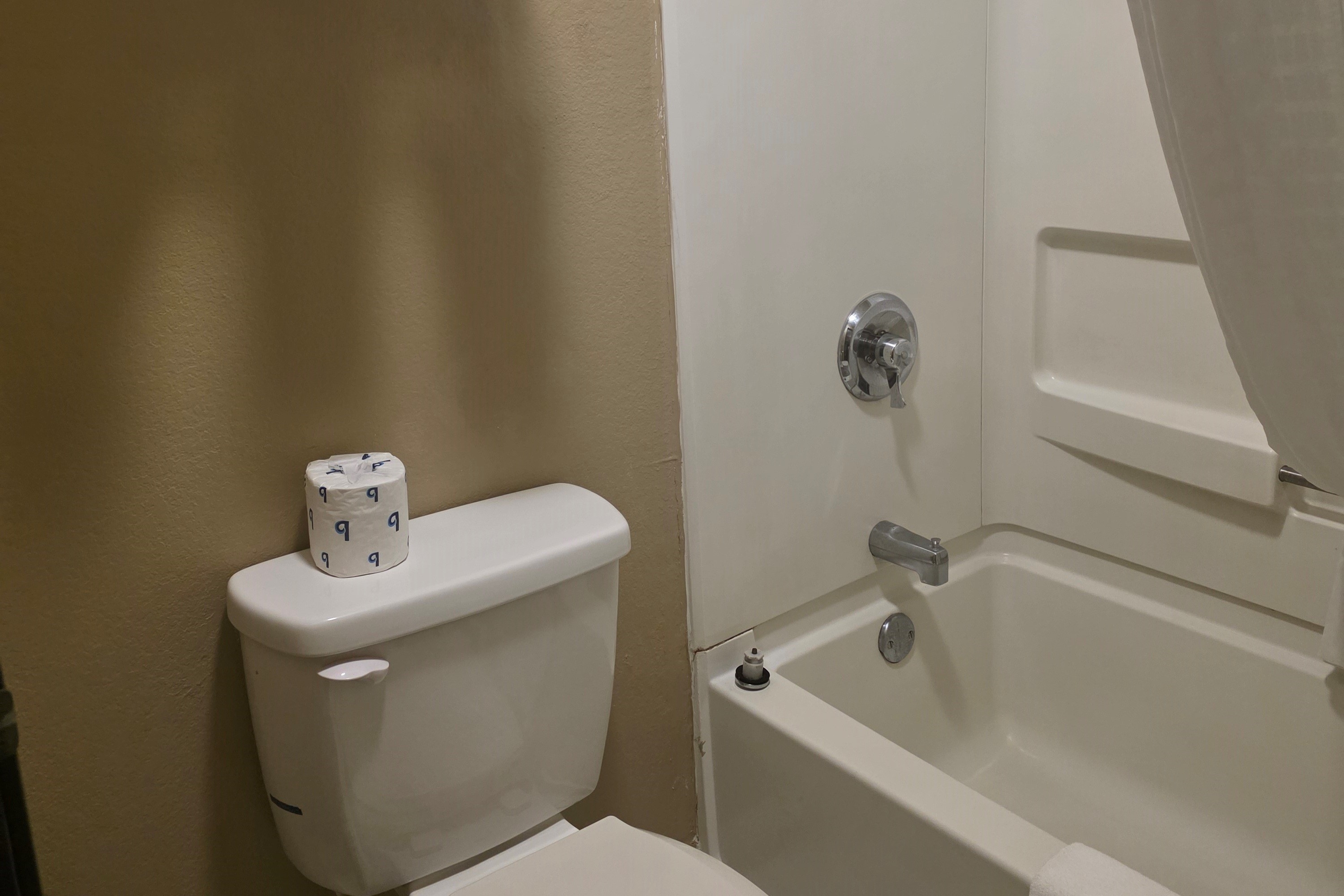 Guest room bath at the Super 8 by Wyndham Coshocton Roscoe Village in Coshocton, Ohio