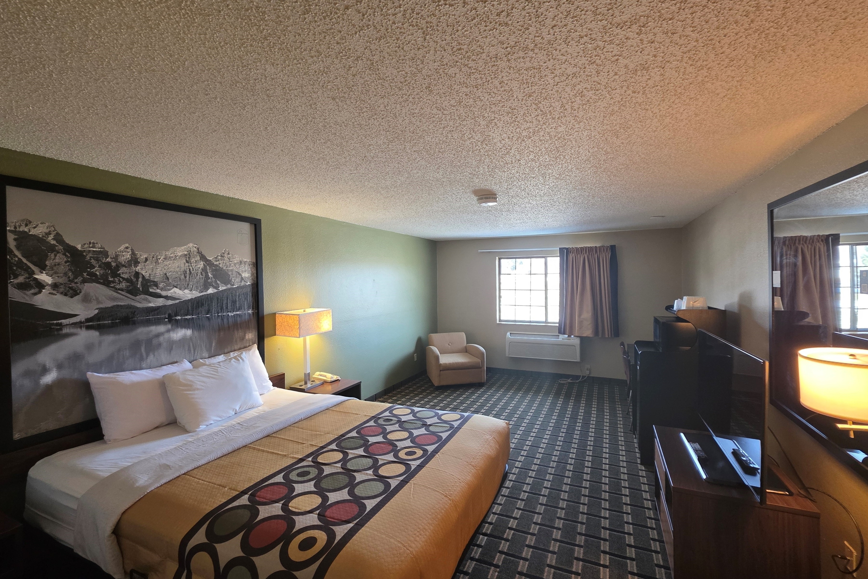 Guest room at the Super 8 by Wyndham Coshocton Roscoe Village in Coshocton, Ohio