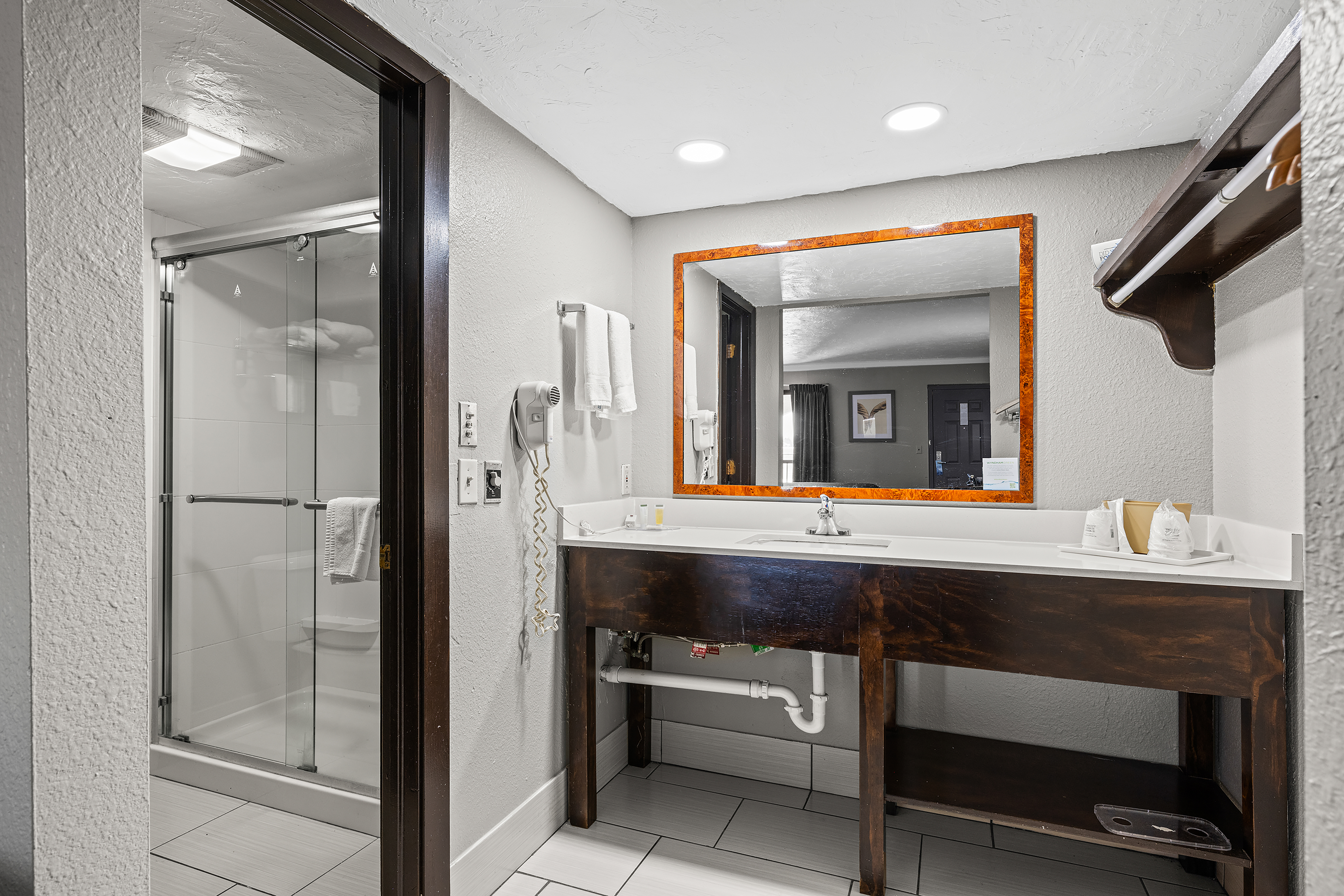 Guest room bath at the Super 8 by Wyndham Norman West in Norman, Oklahoma