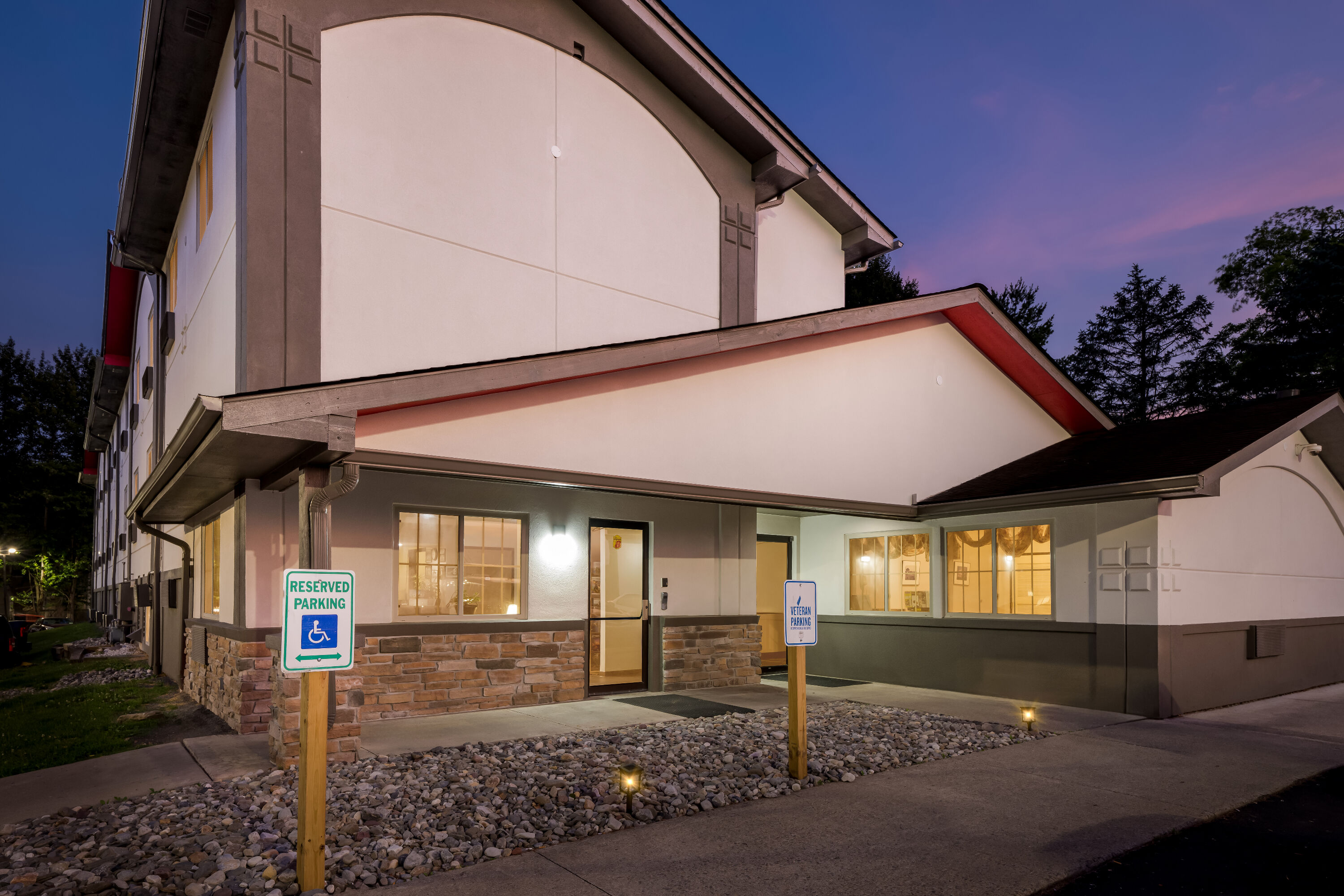 Exterior Night Image of Super 8 by Wyndham East Stroudsburg/Poconos hotel in East Stroudsburg, Pennsylvania