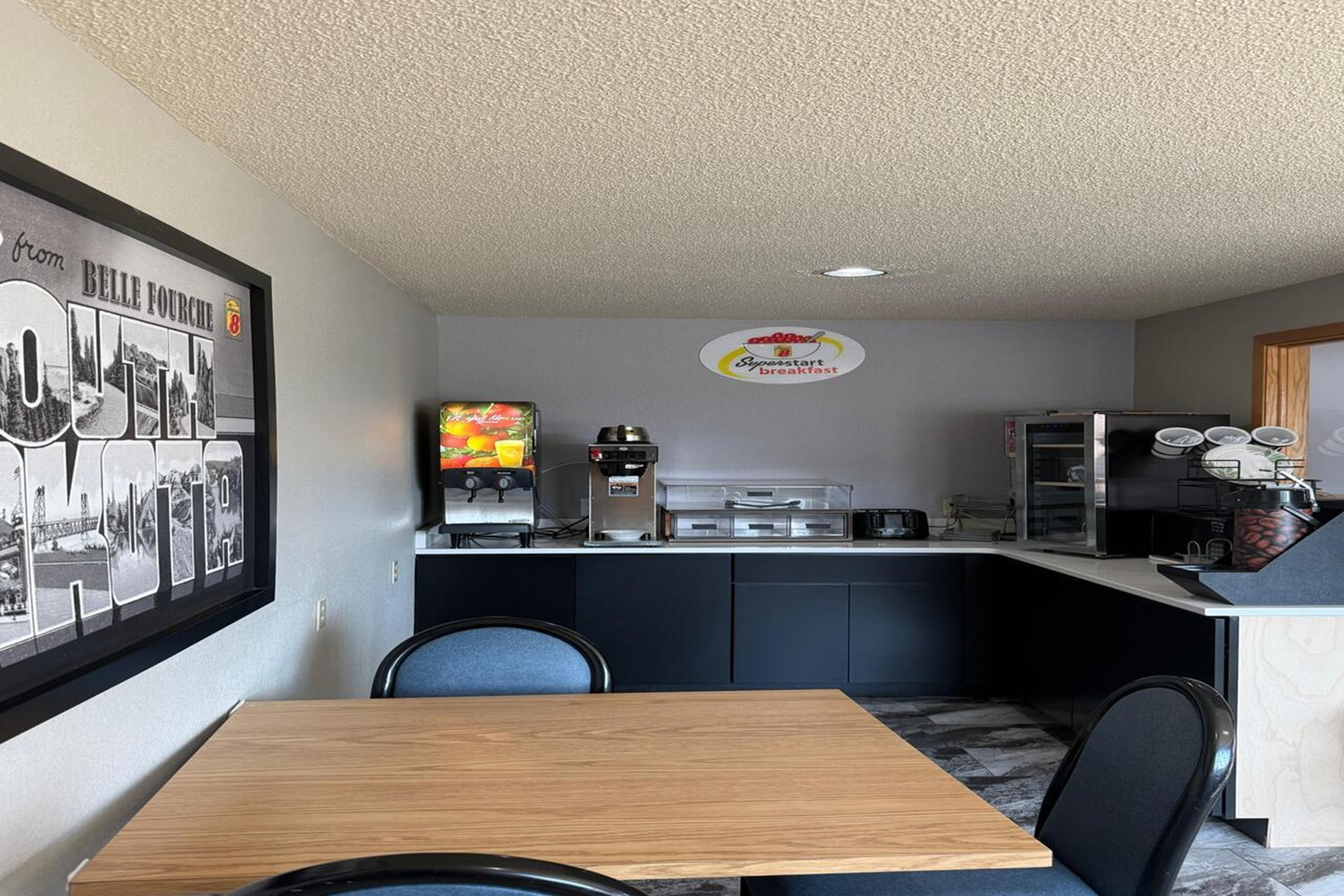 Super 8 by Wyndham Belle Fourche SD restaurant breakfast area with seating in Belle Fourche, South Dakota