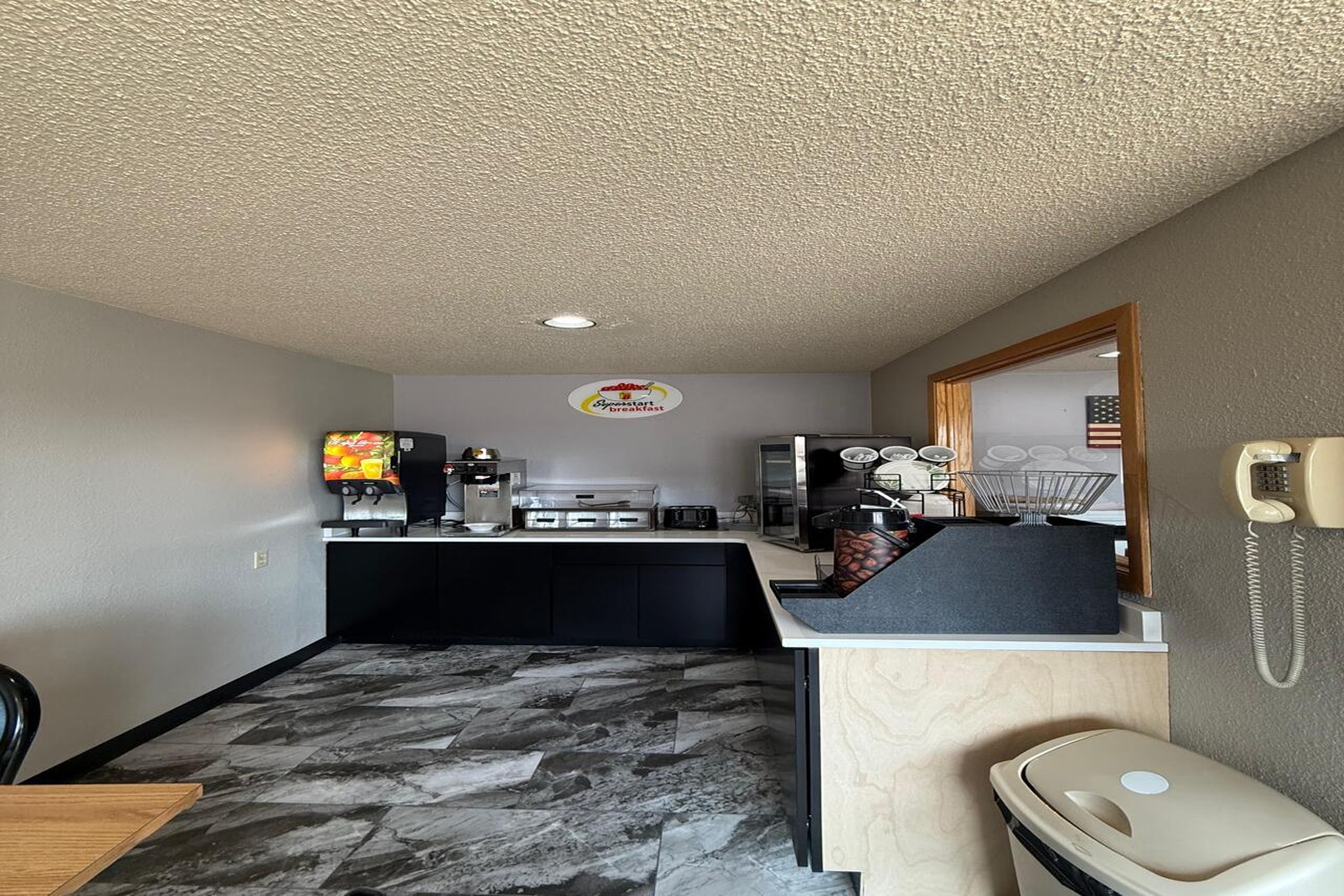 Super 8 by Wyndham Belle Fourche SD restaurant breakfast area with seating in Belle Fourche, South Dakota