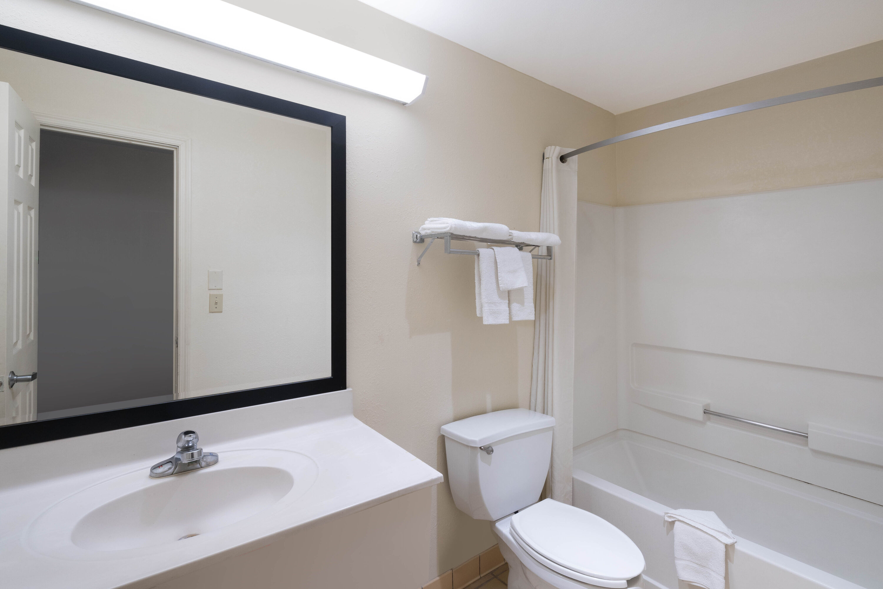 Guest room bath at the Super 8 by Wyndham Cleveland in Cleveland, Tennessee