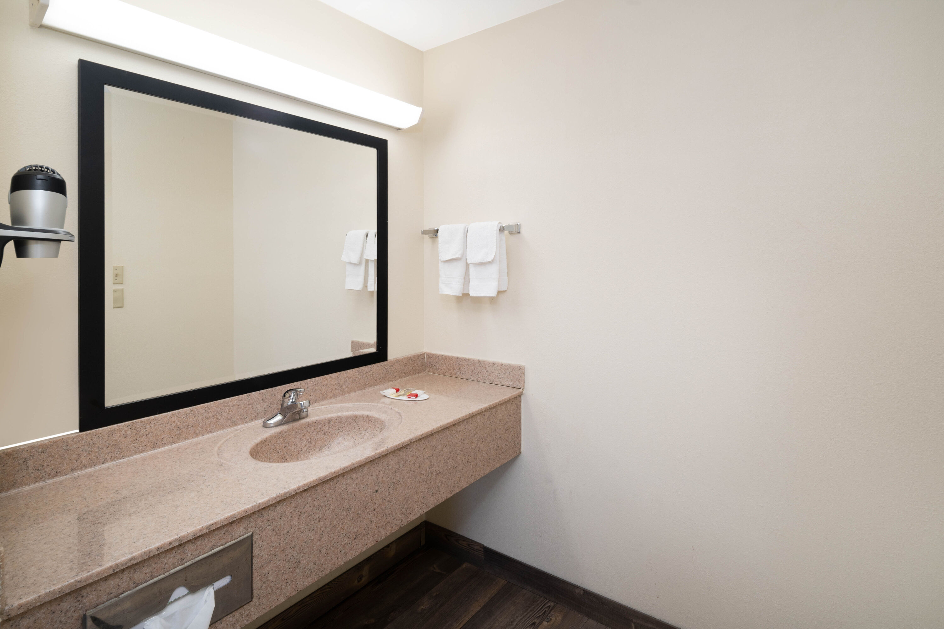 Guest room bath at the Super 8 by Wyndham Cleveland in Cleveland, Tennessee