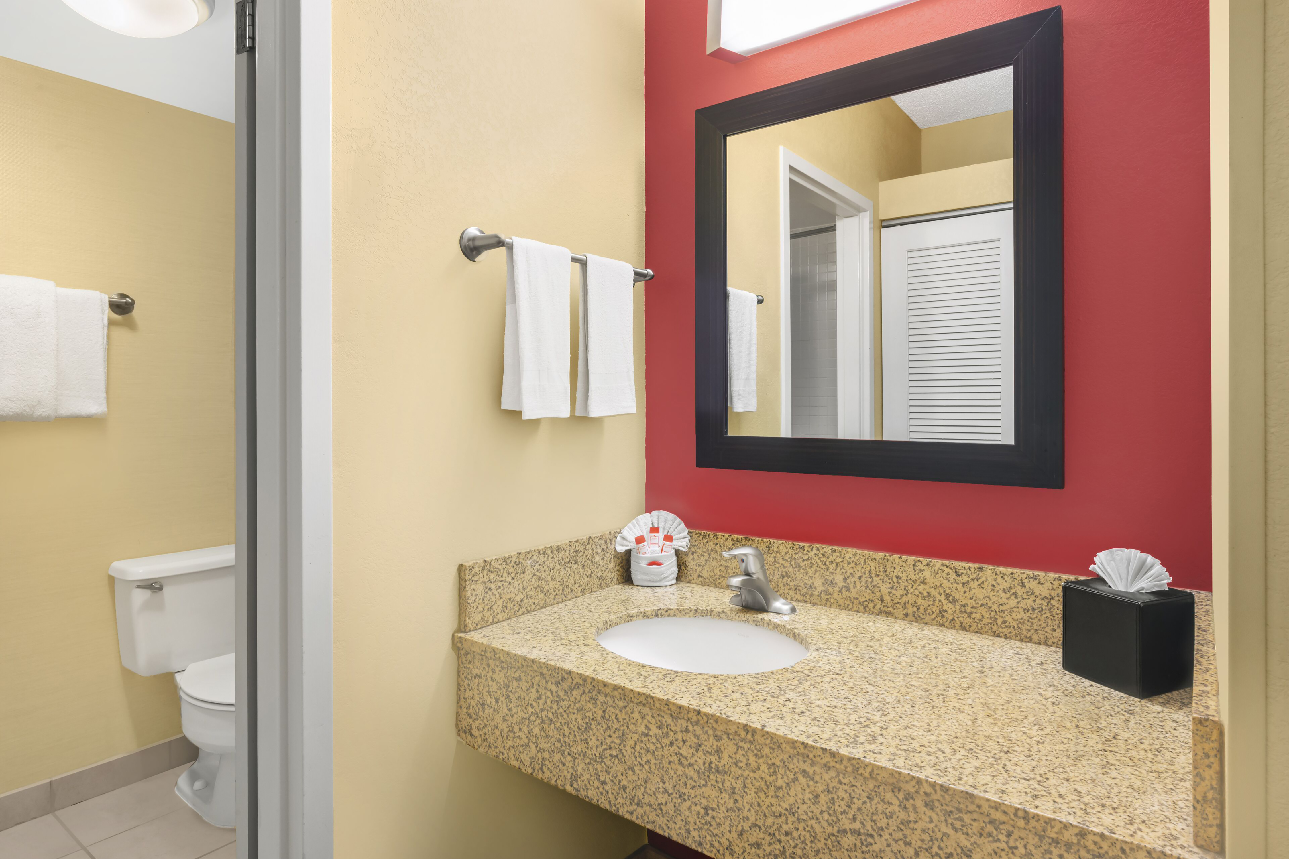 Guest room bath at the Super 8 by Wyndham Dallas Love Field Airport in Dallas, Texas