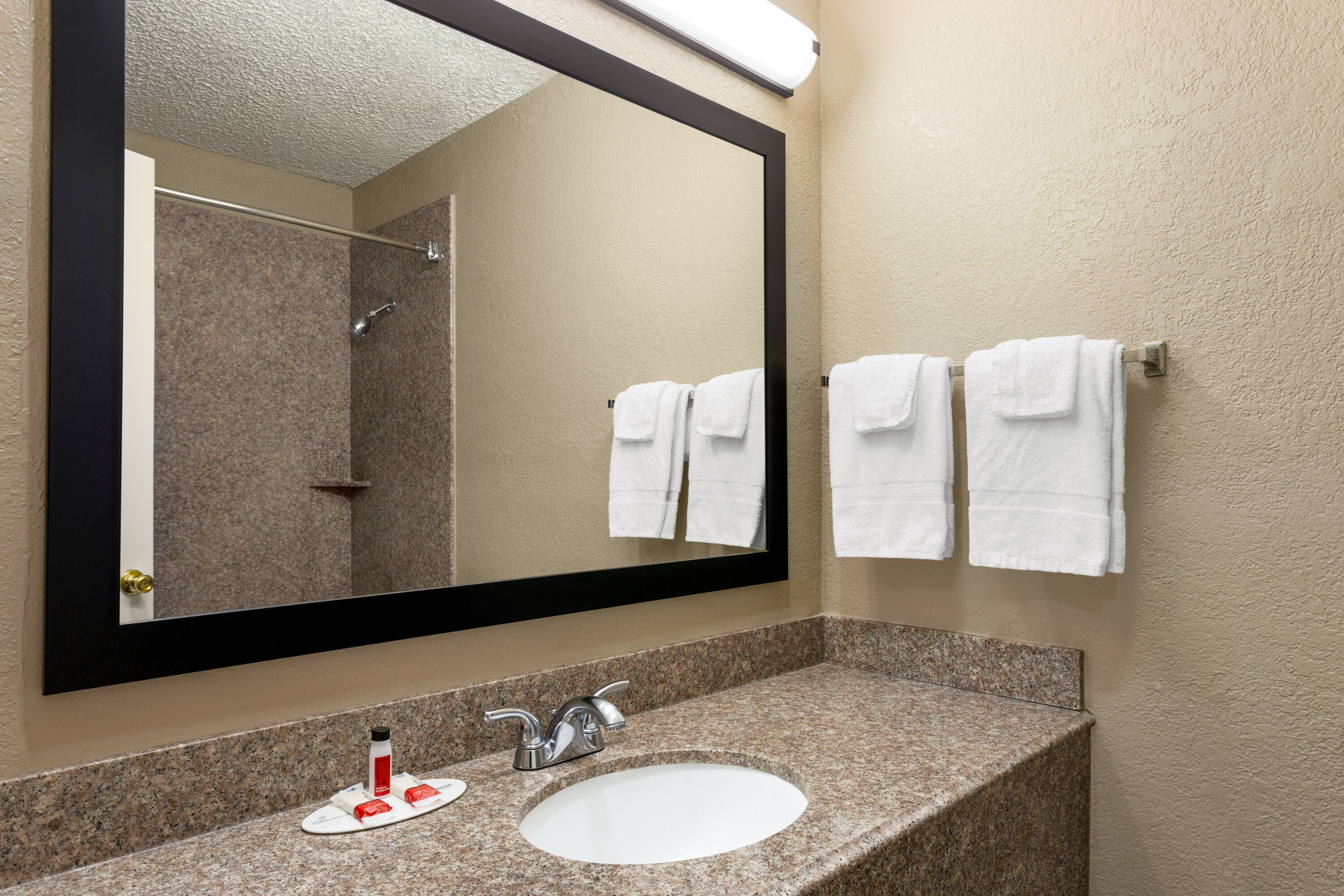 Guest room bath at the Super 8 by Wyndham Gainesville TX in Gainesville, Texas