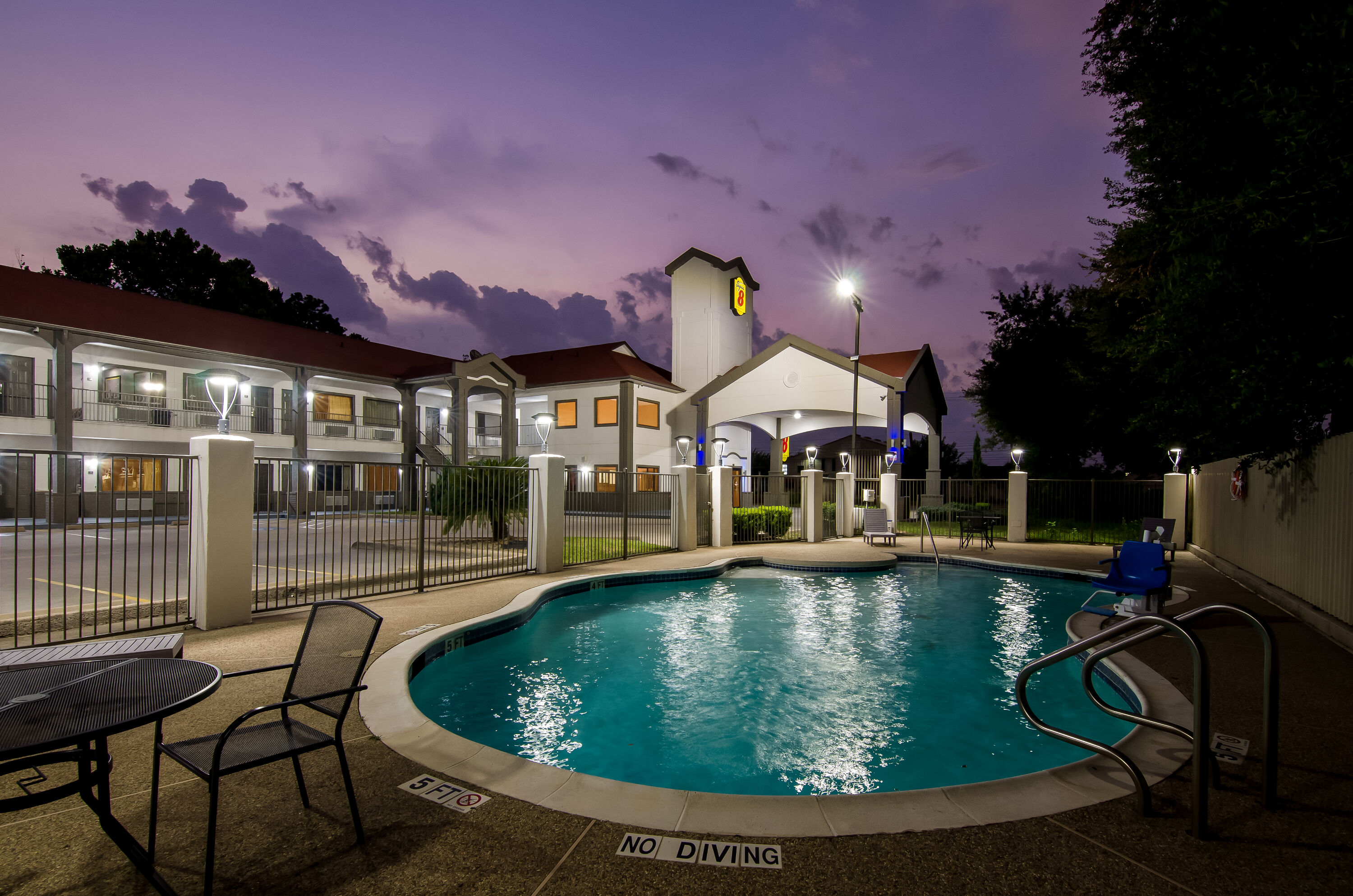 Pool night image at the Super 8 by Wyndham Houston/Brookhollow NW in Houston, Texas