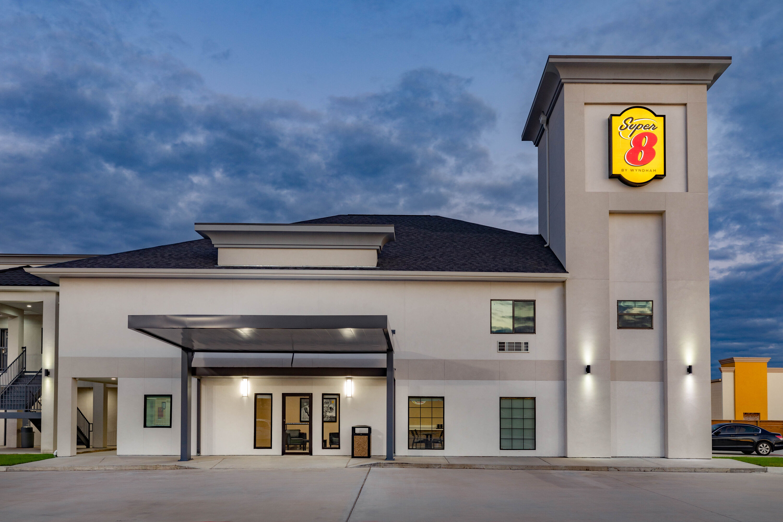 Exterior Dusk Image of Super 8 by Wyndham Houston NW Beltway 8/West Rd hotel in Houston, Texas