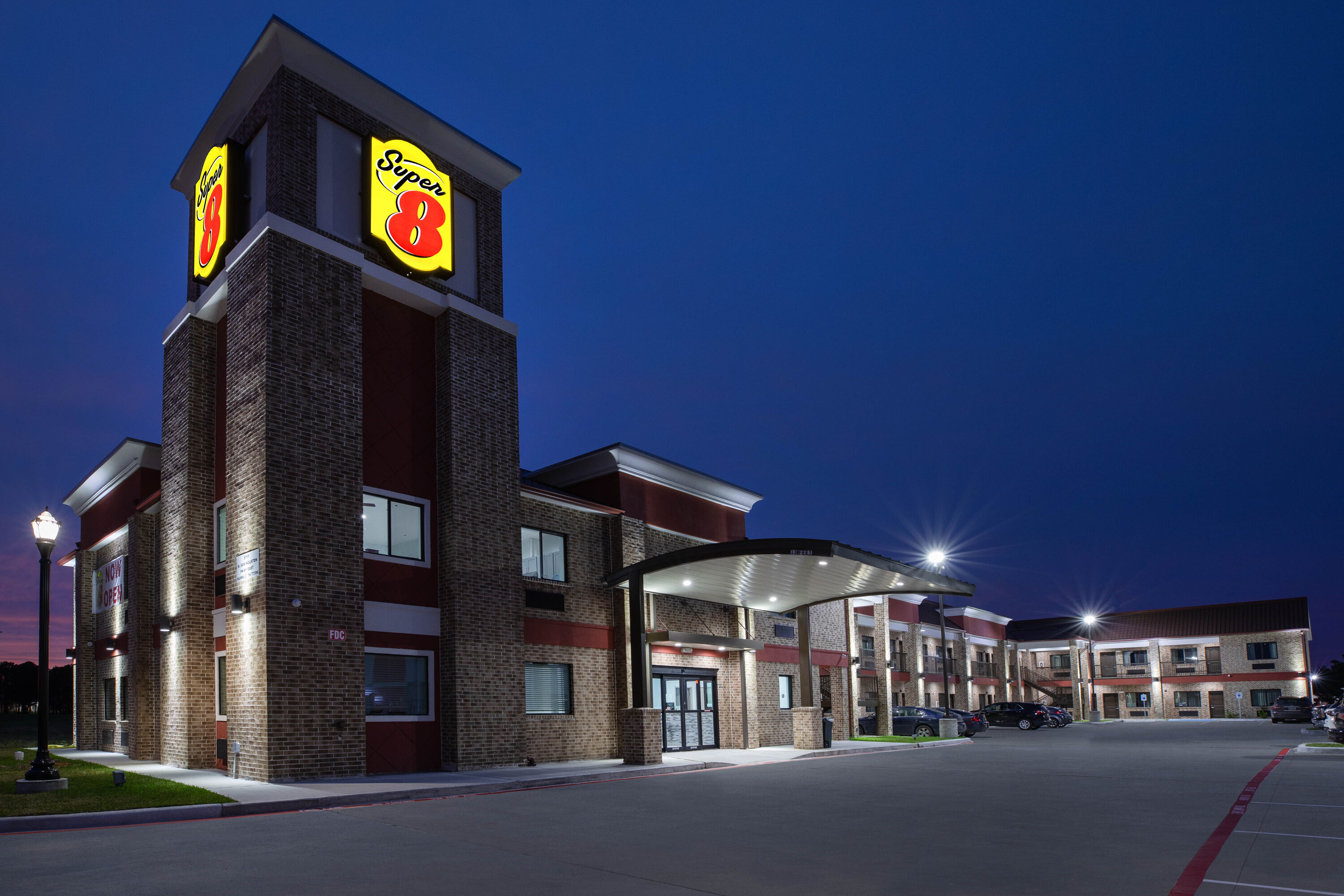 Exterior Night Image of Super 8 by Wyndham Humble/Fallcreek/Houston hotel in Humble, Texas