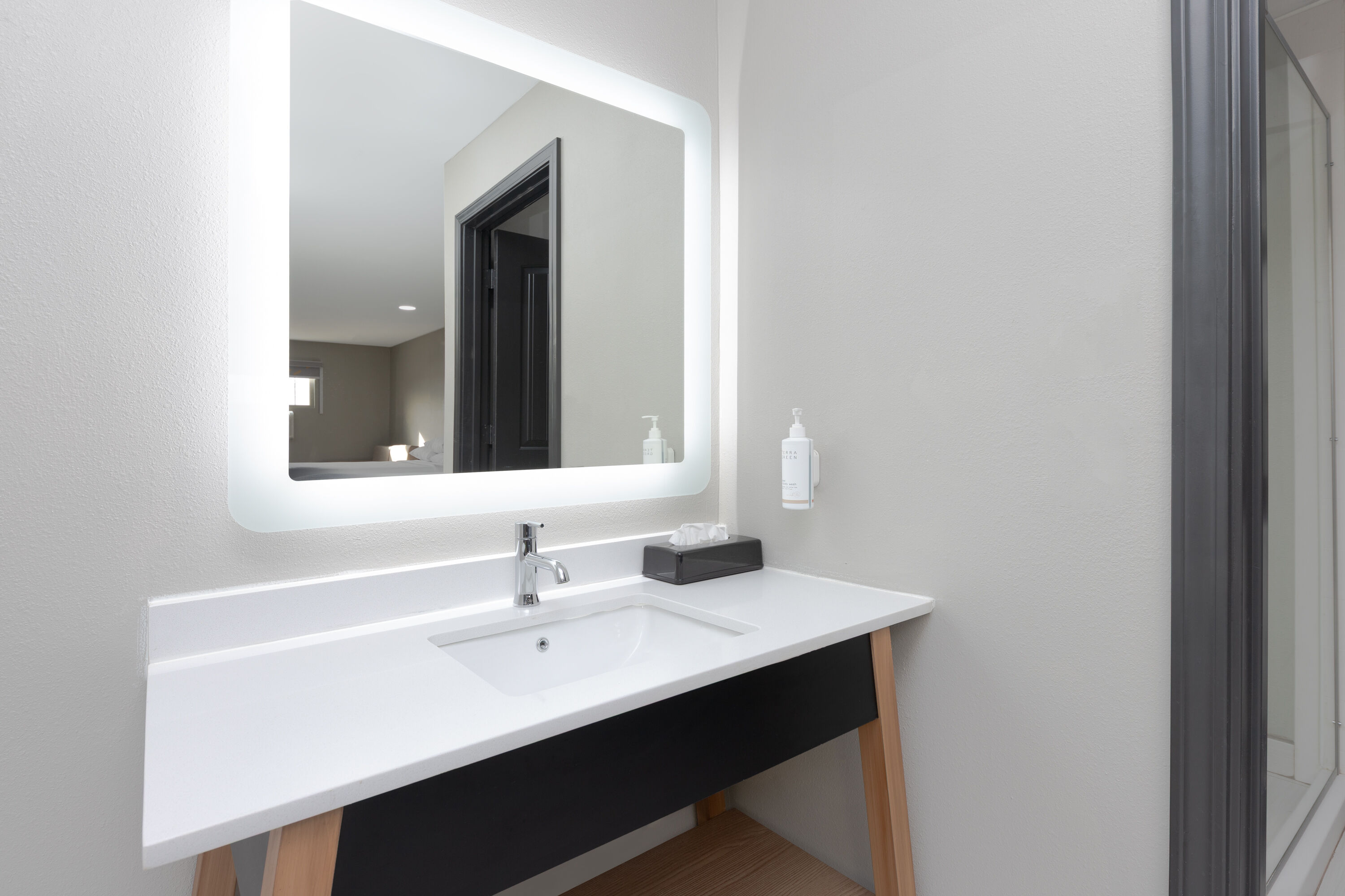 Guest room bath at the Super 8 by Wyndham Lubbock Airport in Lubbock, Texas