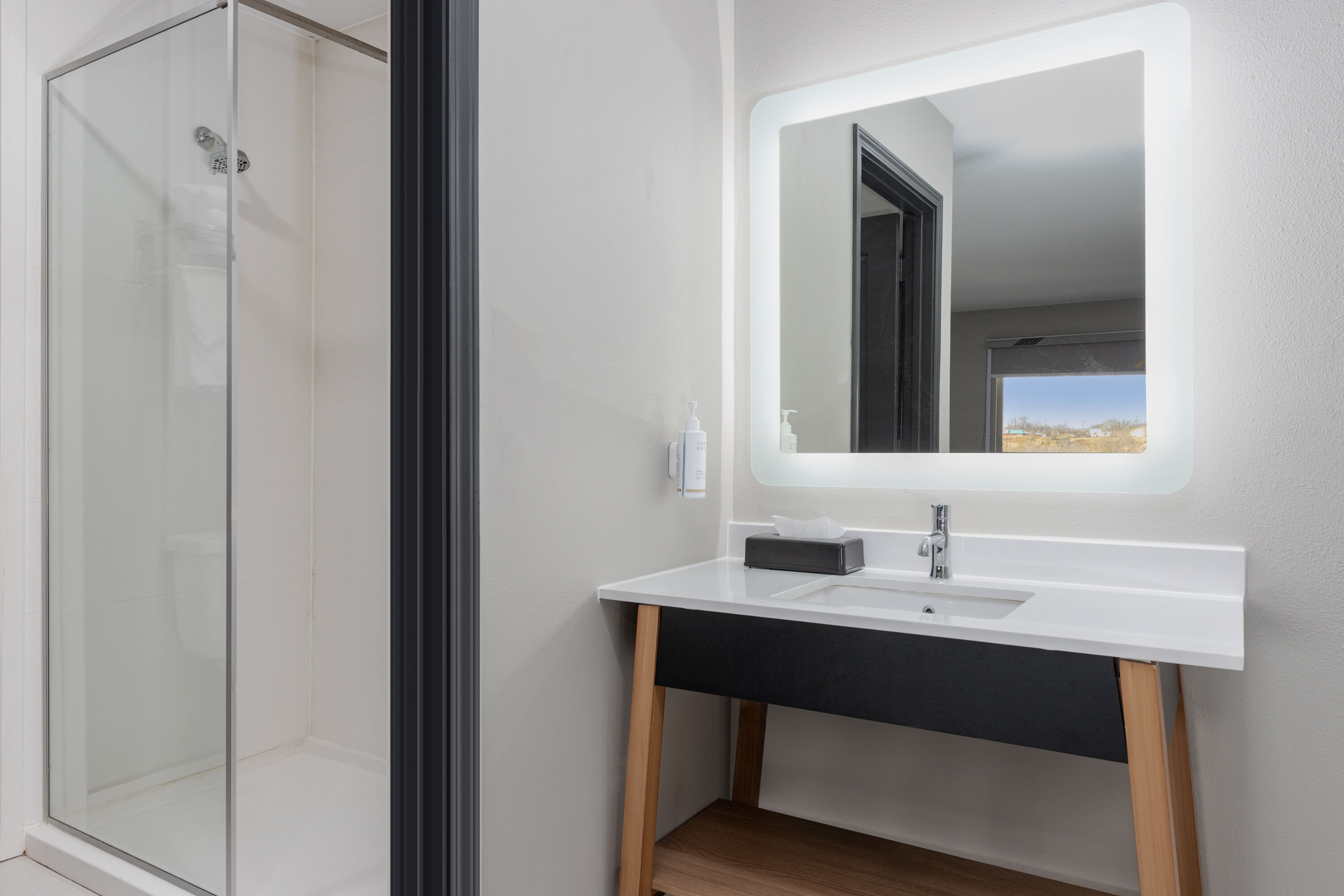 Guest room bath at the Super 8 by Wyndham Lubbock Airport in Lubbock, Texas