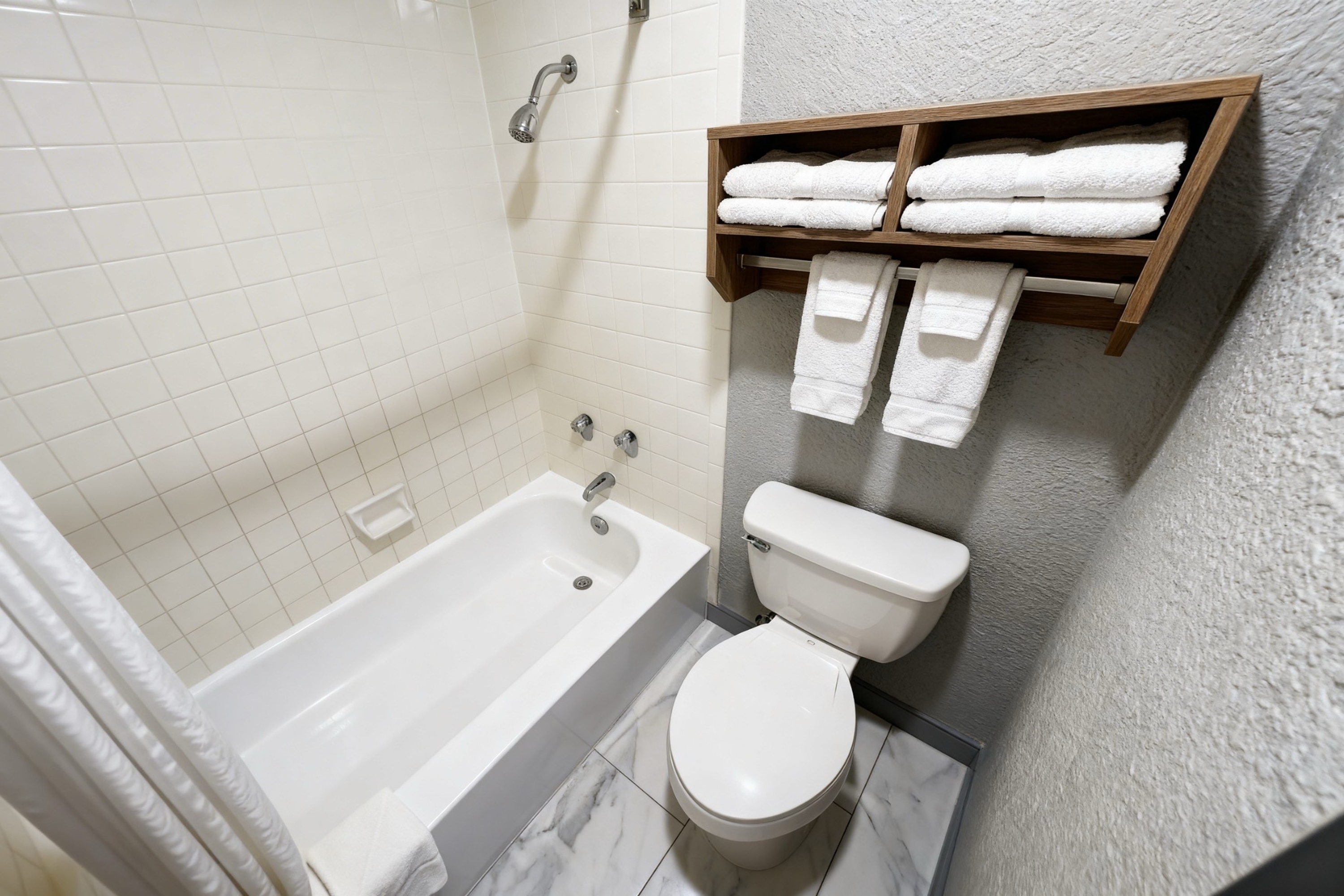 Guest room bath at the Super 8 by Wyndham Nacogdoches Near University in Nacogdoches, Texas