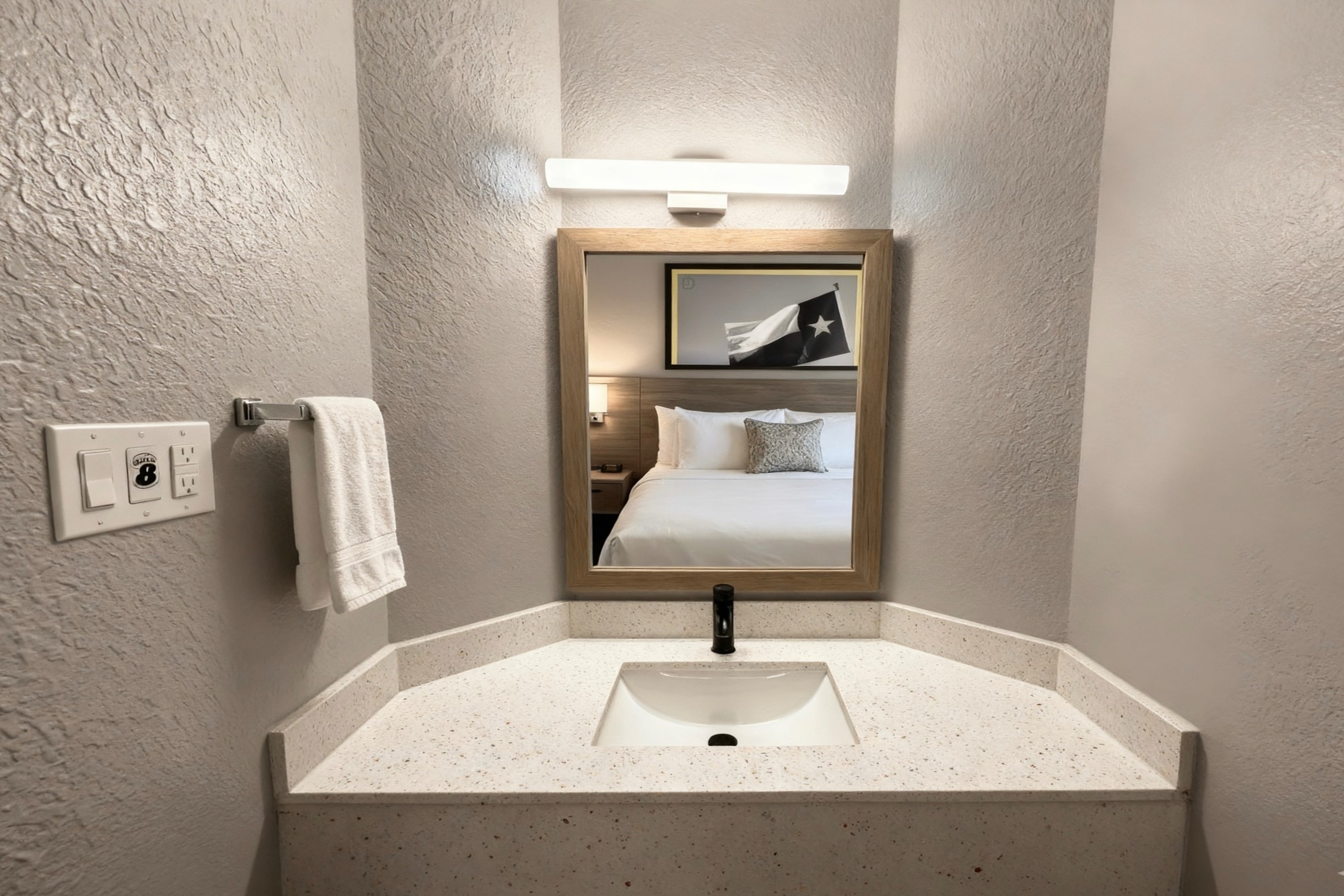 Guest room bath at the Super 8 by Wyndham Nacogdoches Near University in Nacogdoches, Texas